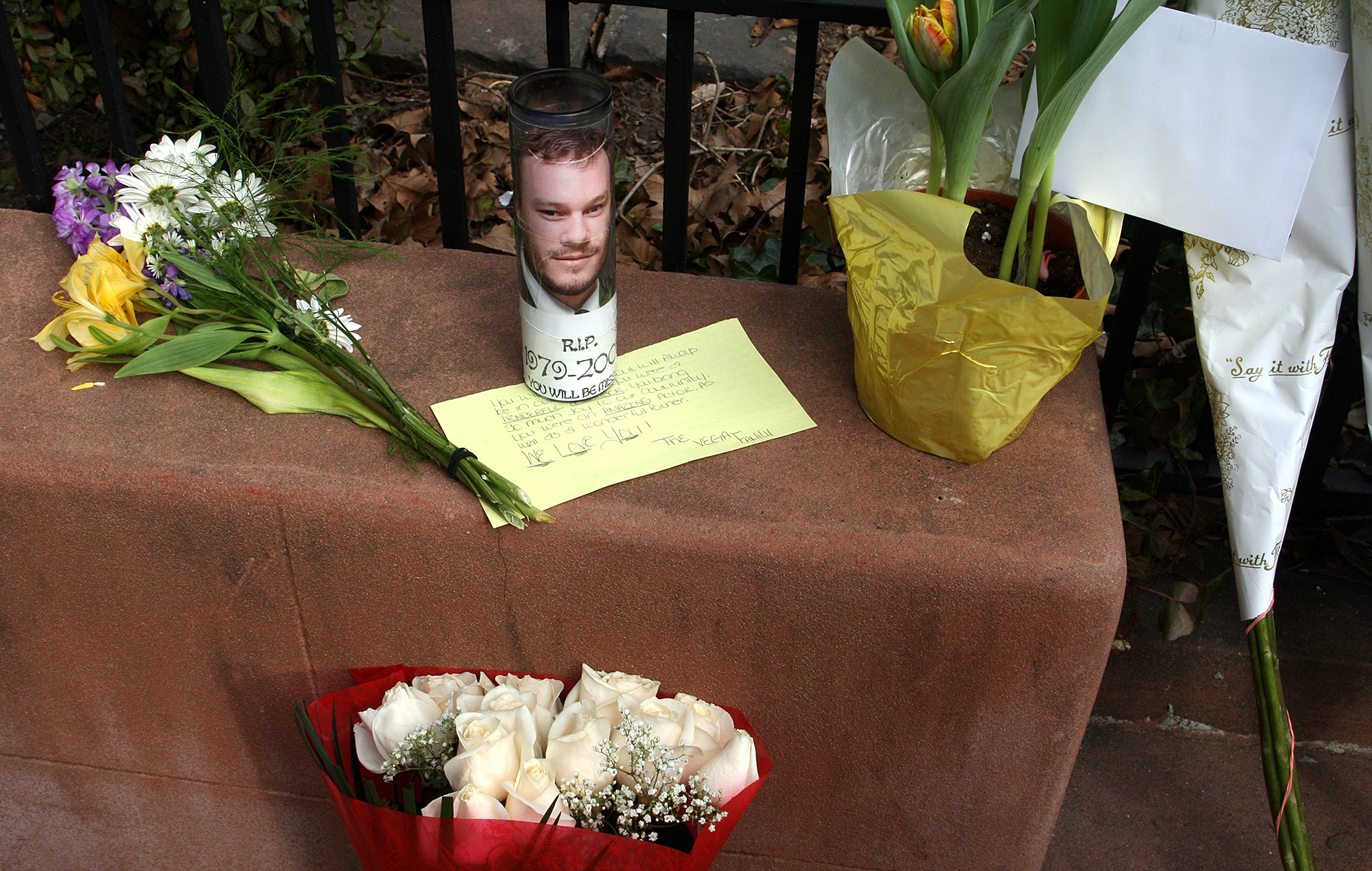 Velas, flores y notas dejadas en la puerta de Michelle William y Matilda Ledger tras la muerte de Heath Ledger | Fuente: Getty Images