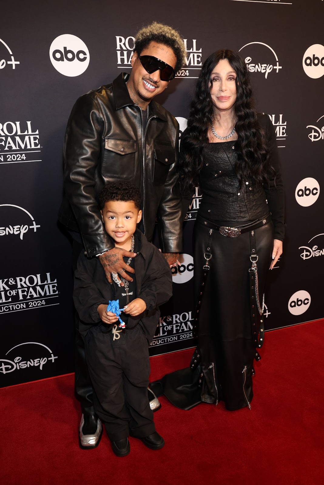 Slash Electric Alexander y Alexander "AE" Edwards con Cher en la Ceremonia de Inducción al Salón de la Fama del Rock & Roll 2024 el 19 de octubre en Cleveland, Ohio | Fuente: Getty Images