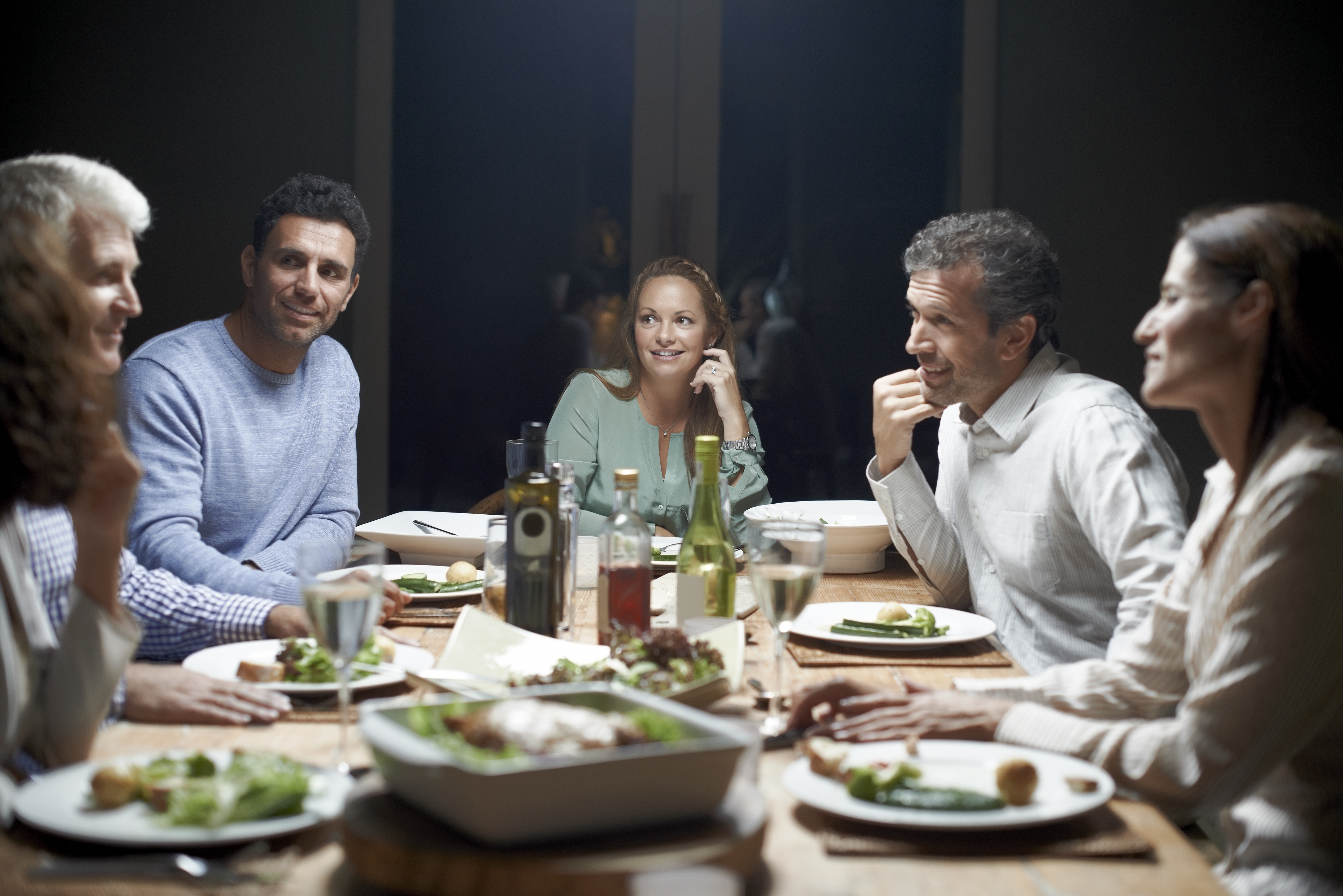 Amigos cenan en la mesa | Fuente: Getty Images