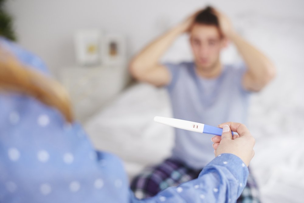 Hombre sorprendido recibe resultado de prueba de embarazo. || Fuente: Shutterstock