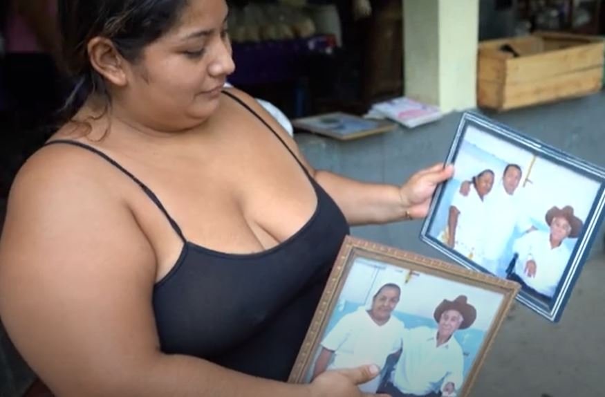 Raquel Barrera mostrando fotos de su familia. | Foto: Youtube/AFP Español