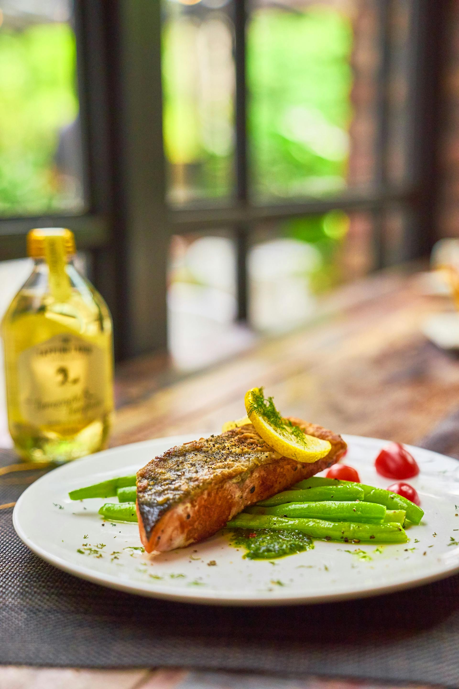 Filete de pescado asado con judías verdes y limón servido en plato | Fuente: Pexels