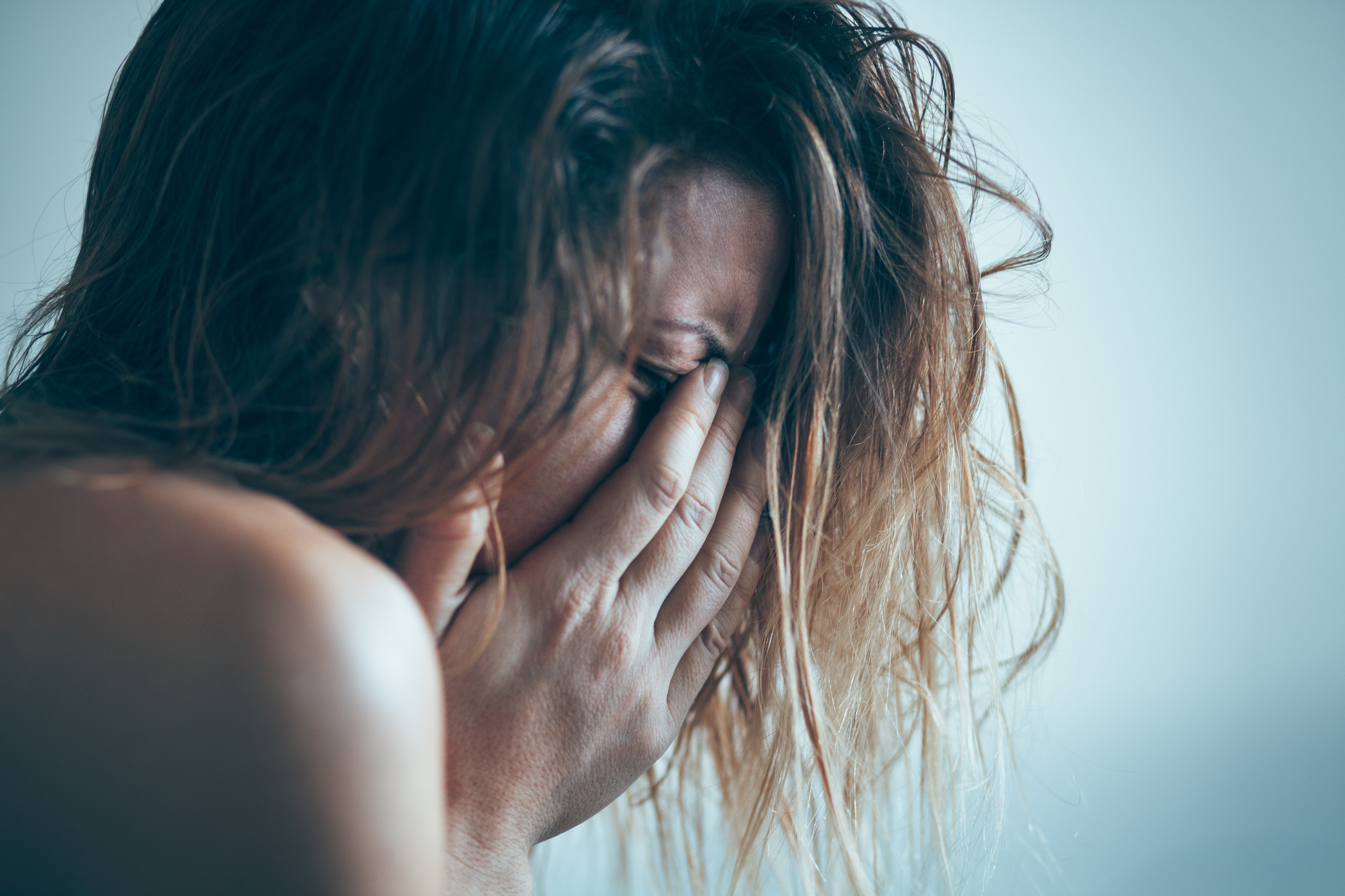 Mujer joven triste y llorando | Fuente: Shutterstock