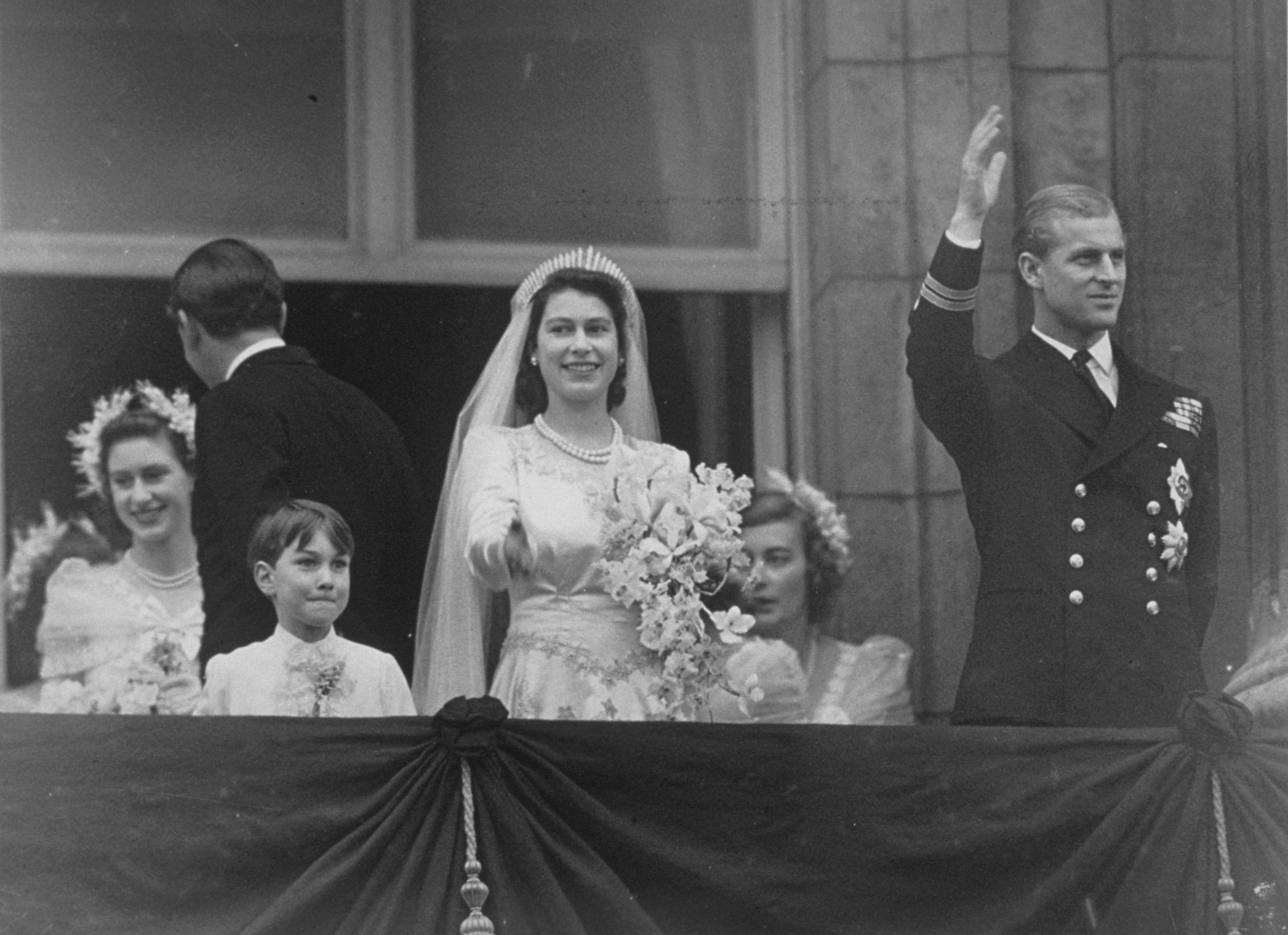 Elizabeth II y el príncipe Philip saludan a la multitud desde el balcón del Palacio de Buckingham tras su boda. | Foto: Getty Images