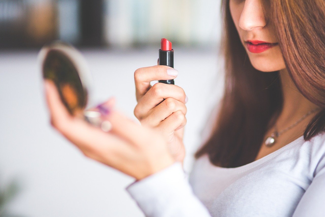 Mujer pintando sus labios. | Foto: Pixabay