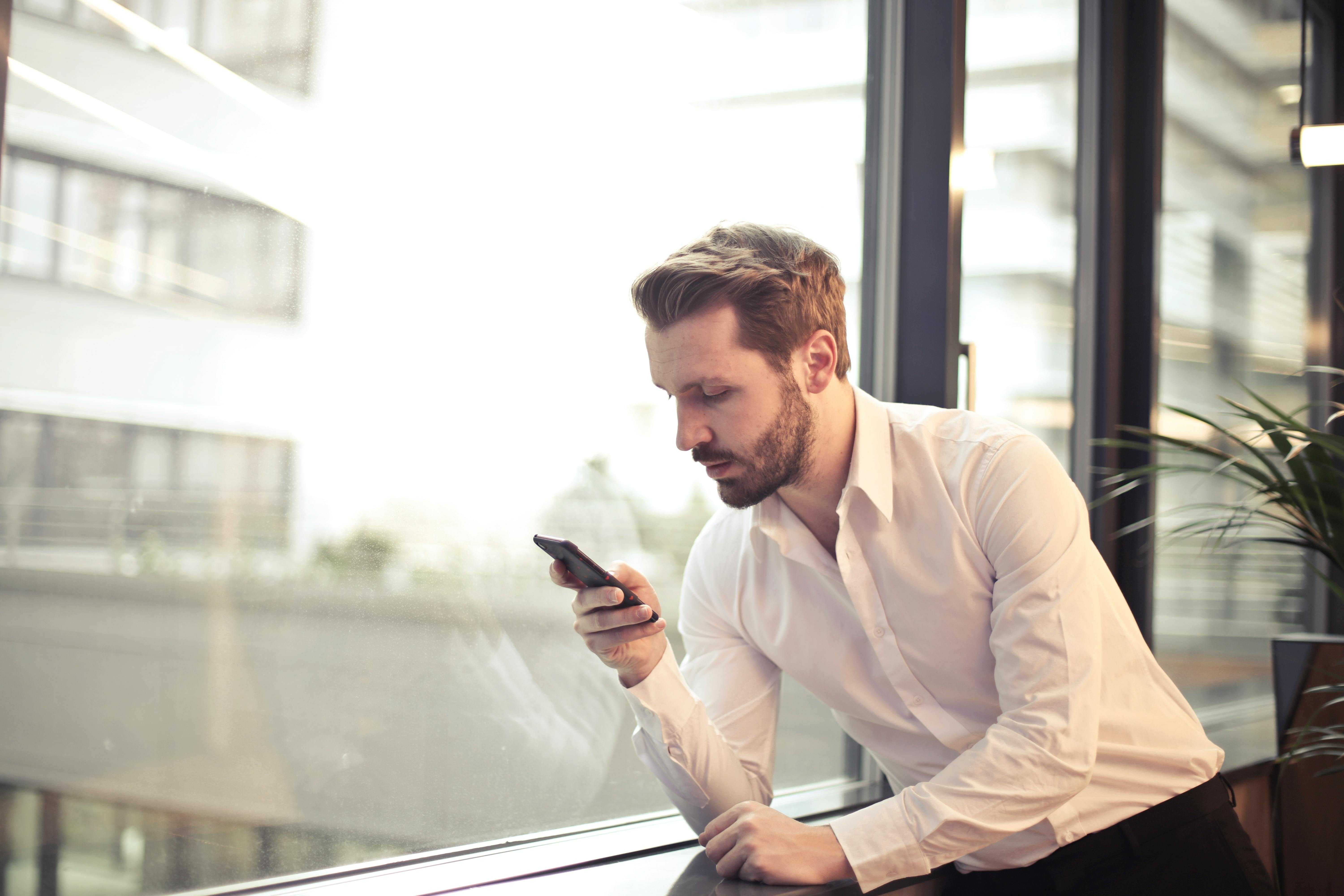 Un hombre mirando su teléfono | Fuente: Pexels