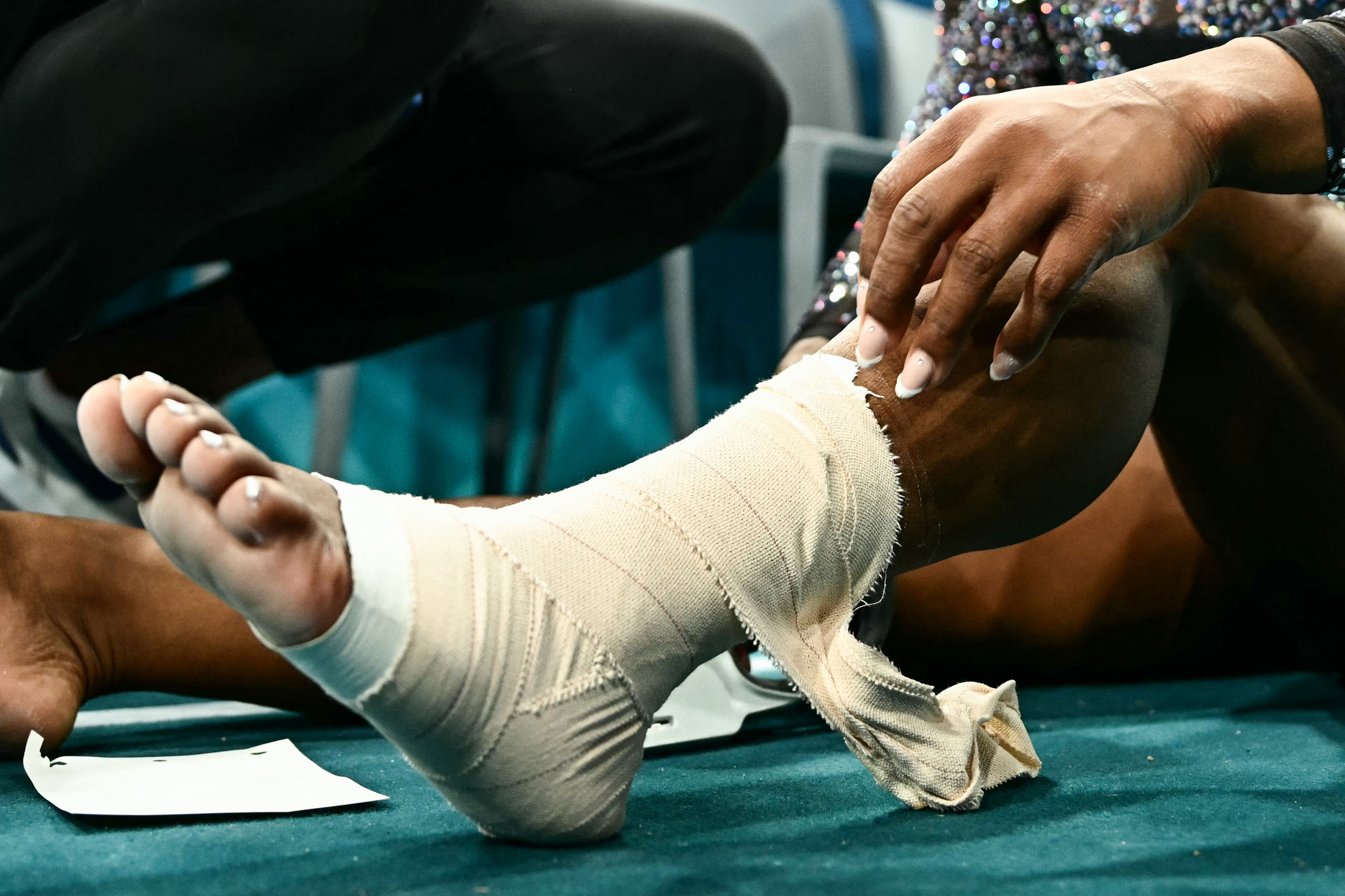 Primer plano del tobillo y la pantorrilla vendados de Simone Biles durante la clasificación femenina de gimnasia artística en París, Francia, el 28 de julio de 2024 | Fuente: Getty Images