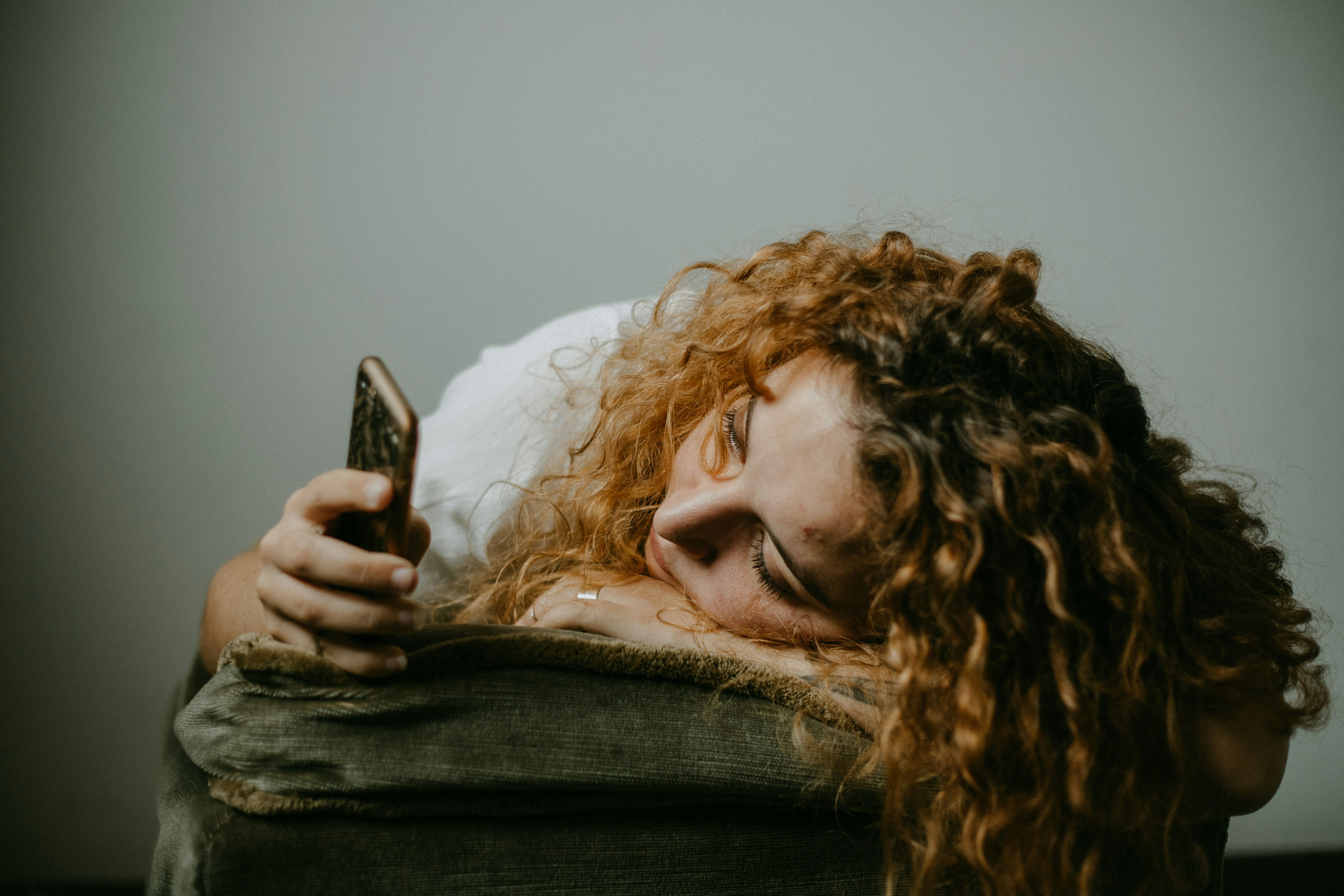 Una mujer triste con su teléfono | Fuente: Unsplash