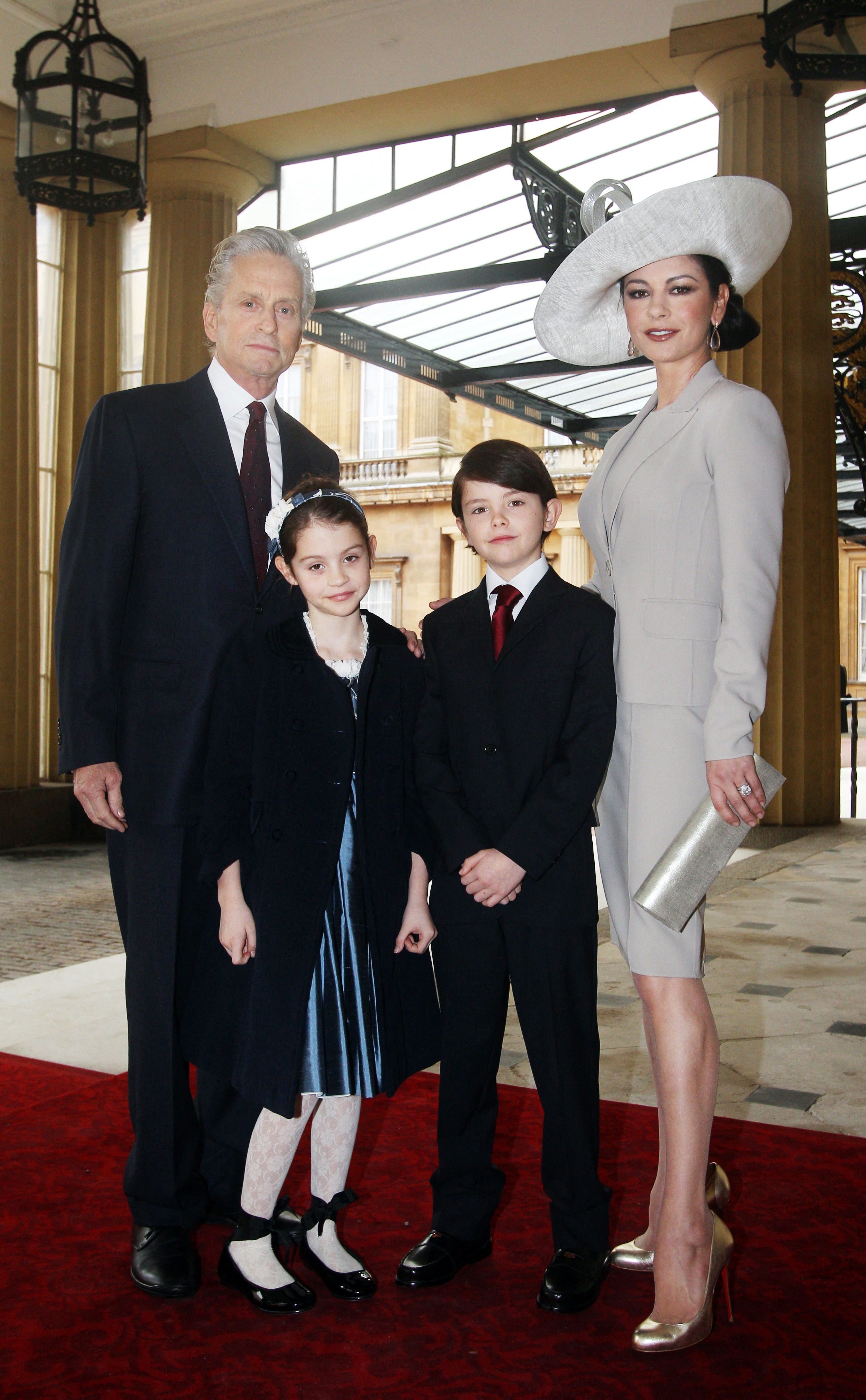 Catherine Zeta-Jones, Michael Douglas y sus hijos Dylan y Carys en el Palacio de Buckingham, en el centro de Londres, el 24 de febrero de 2011 | Fuente: Getty Images