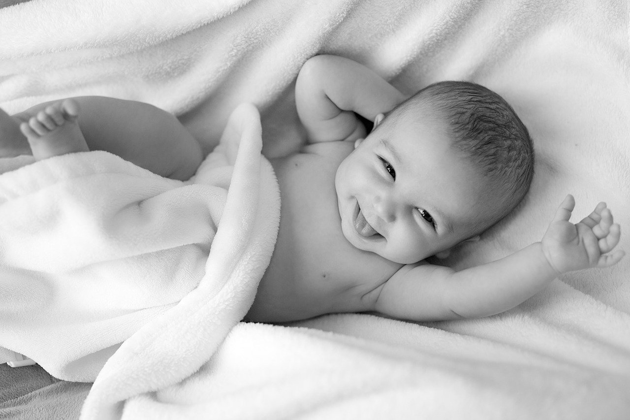 Bebé acostado sonriendo. | Foto: Pixabay