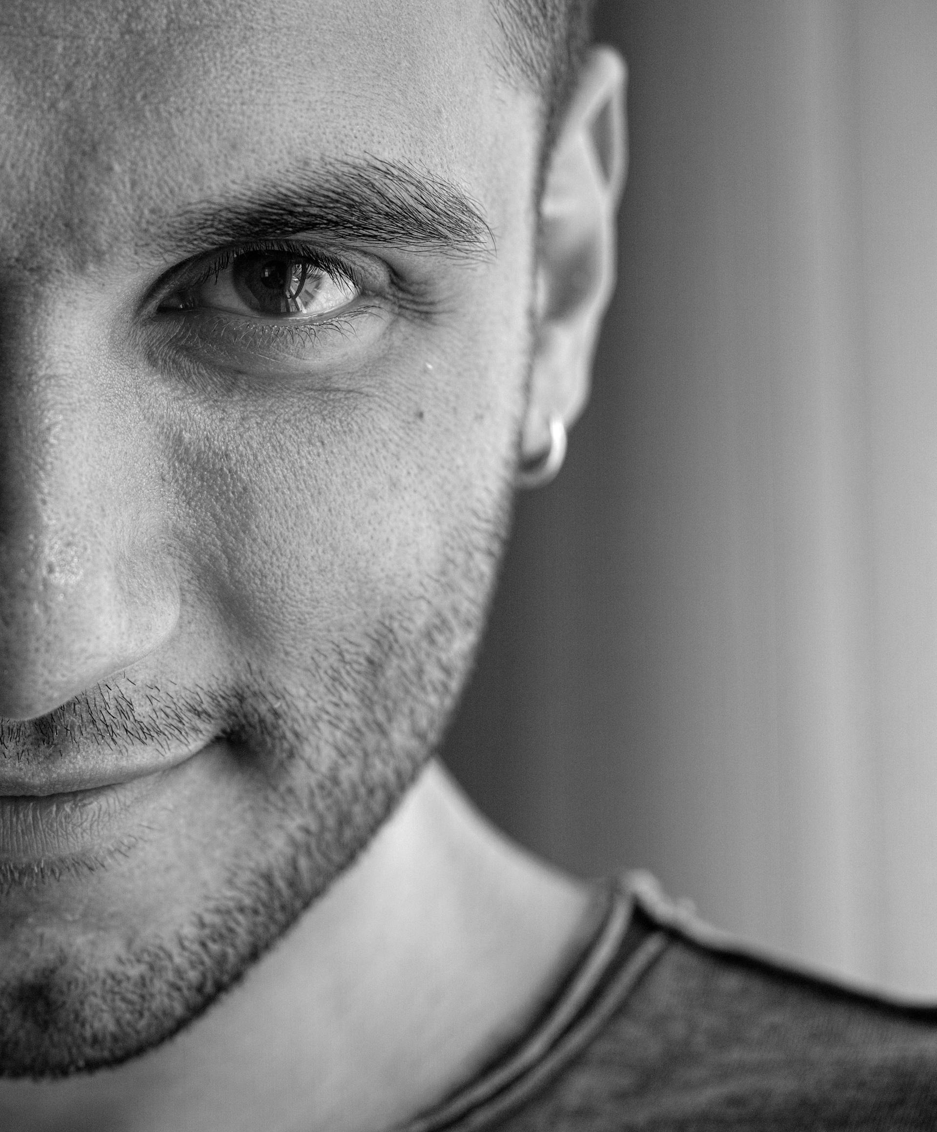 Un hombre sonriendo débilmente | Fuente: Pexels