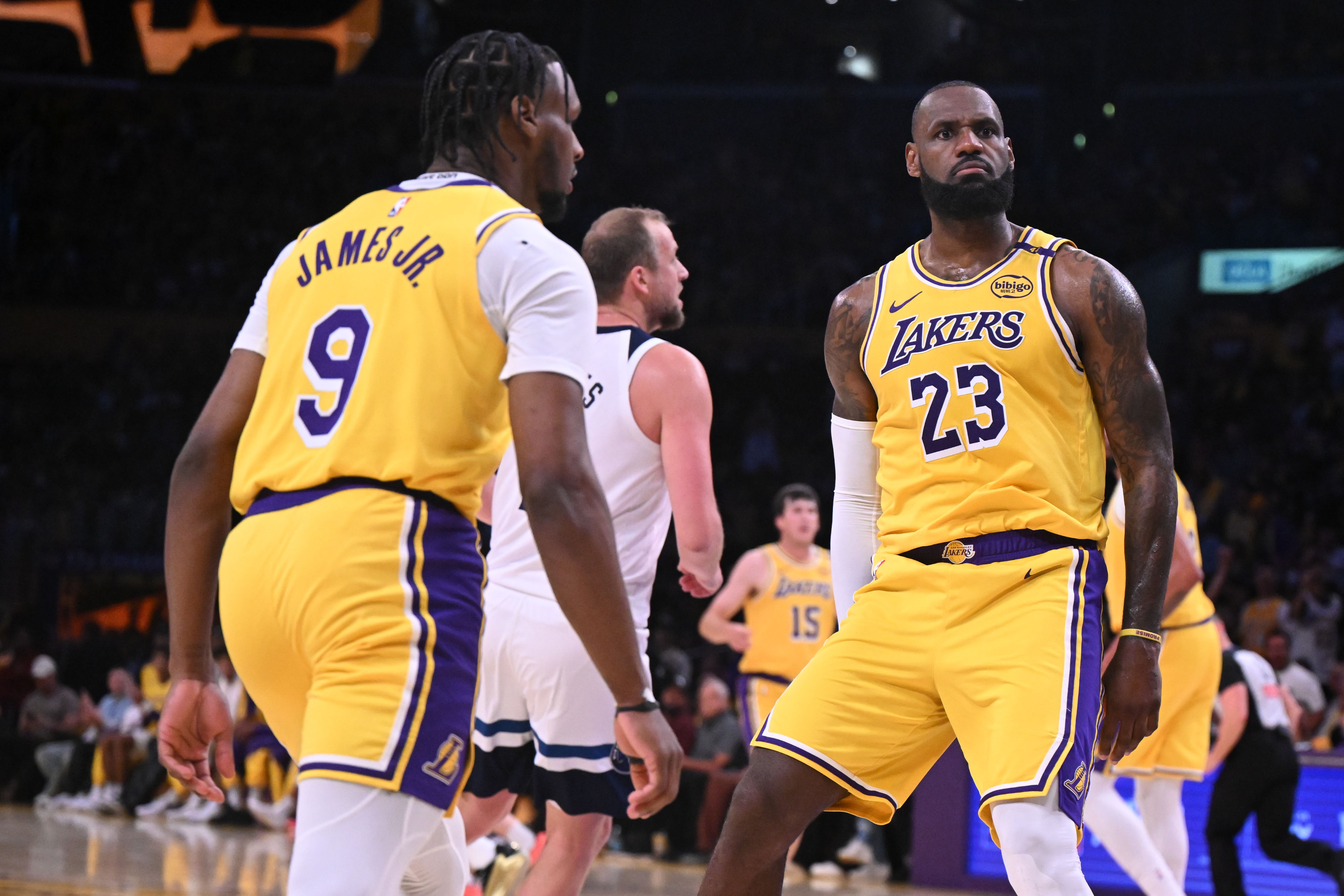 LeBron James reacciona tras anotar dos puntos mientras Bronny James mira durante el segundo cuarto el 22 de octubre de 2024 | Fuente: Getty Images