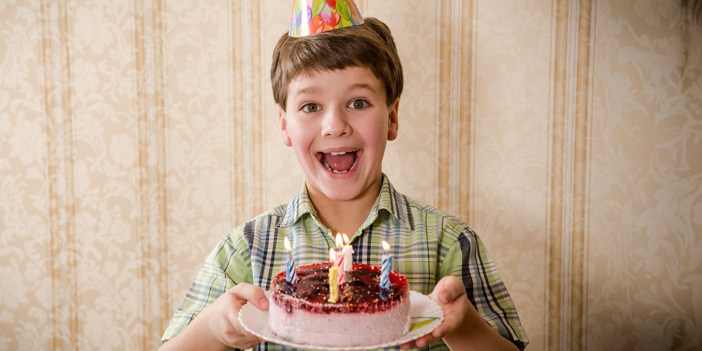 Un niño con un pastel de cumpleaños | Fuente: Shutterstock