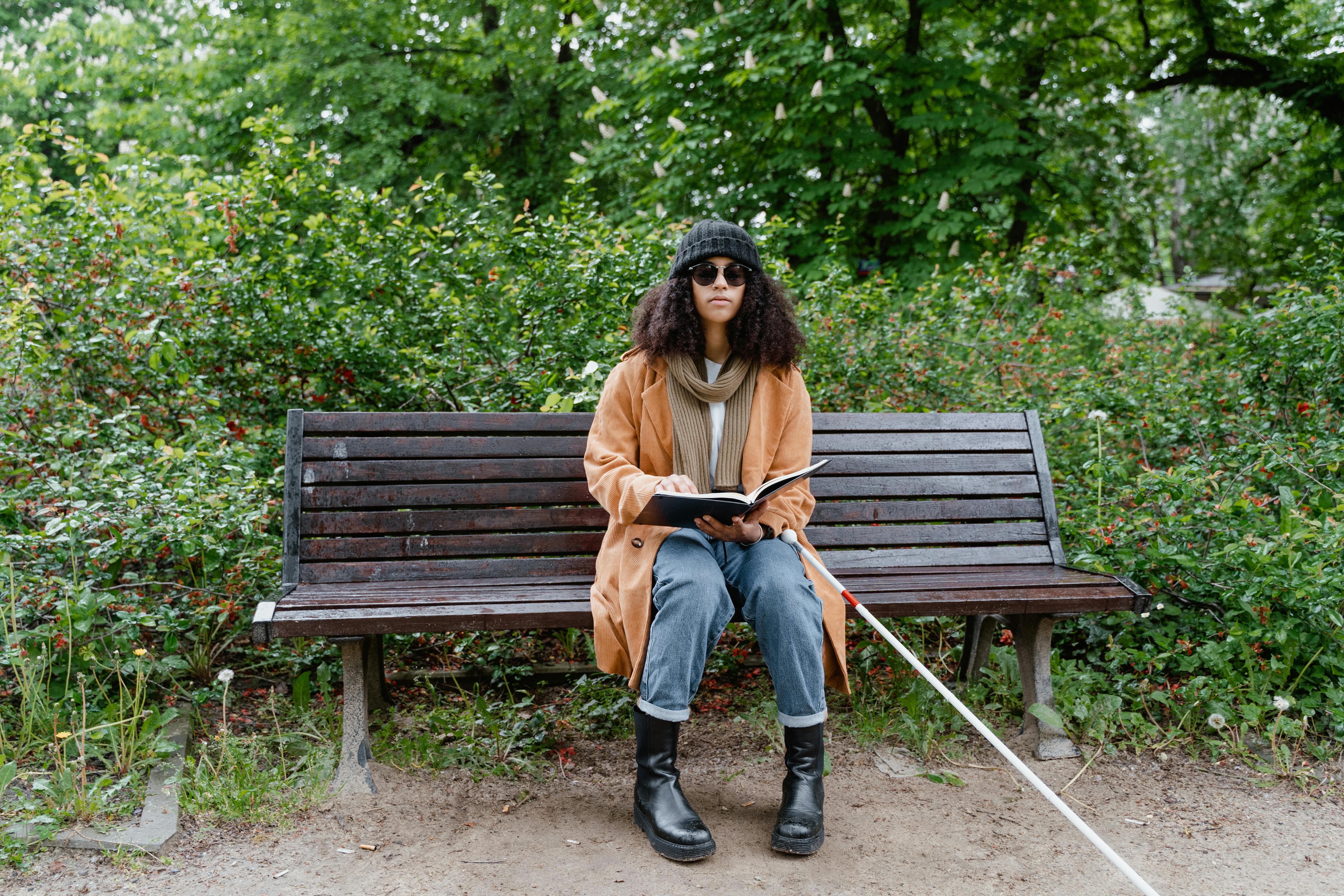 Mujer invidente en un banco del parque | Foto: Pexels