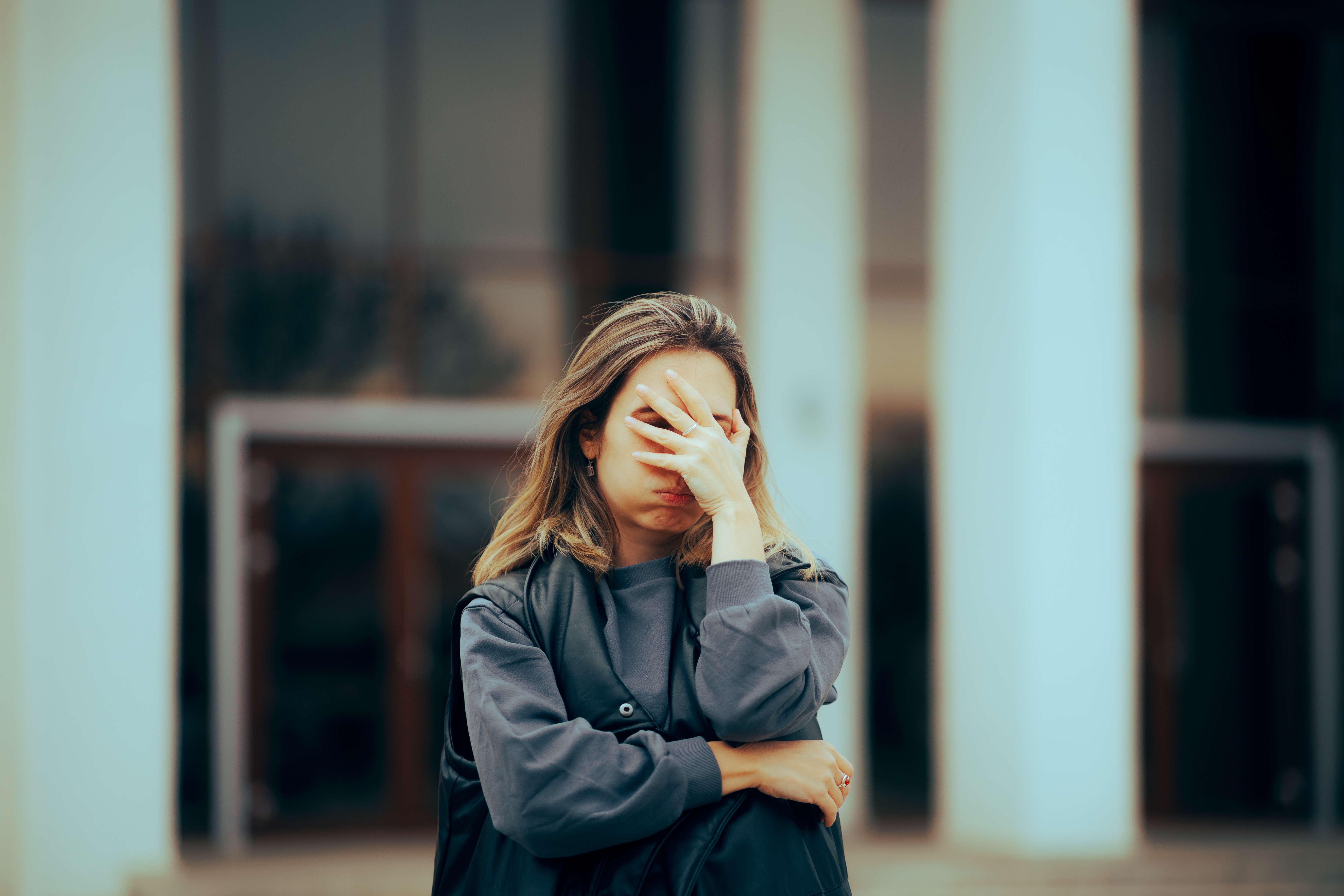 Una mujer se cubre la cara con la mano | Fuente: Shutterstock