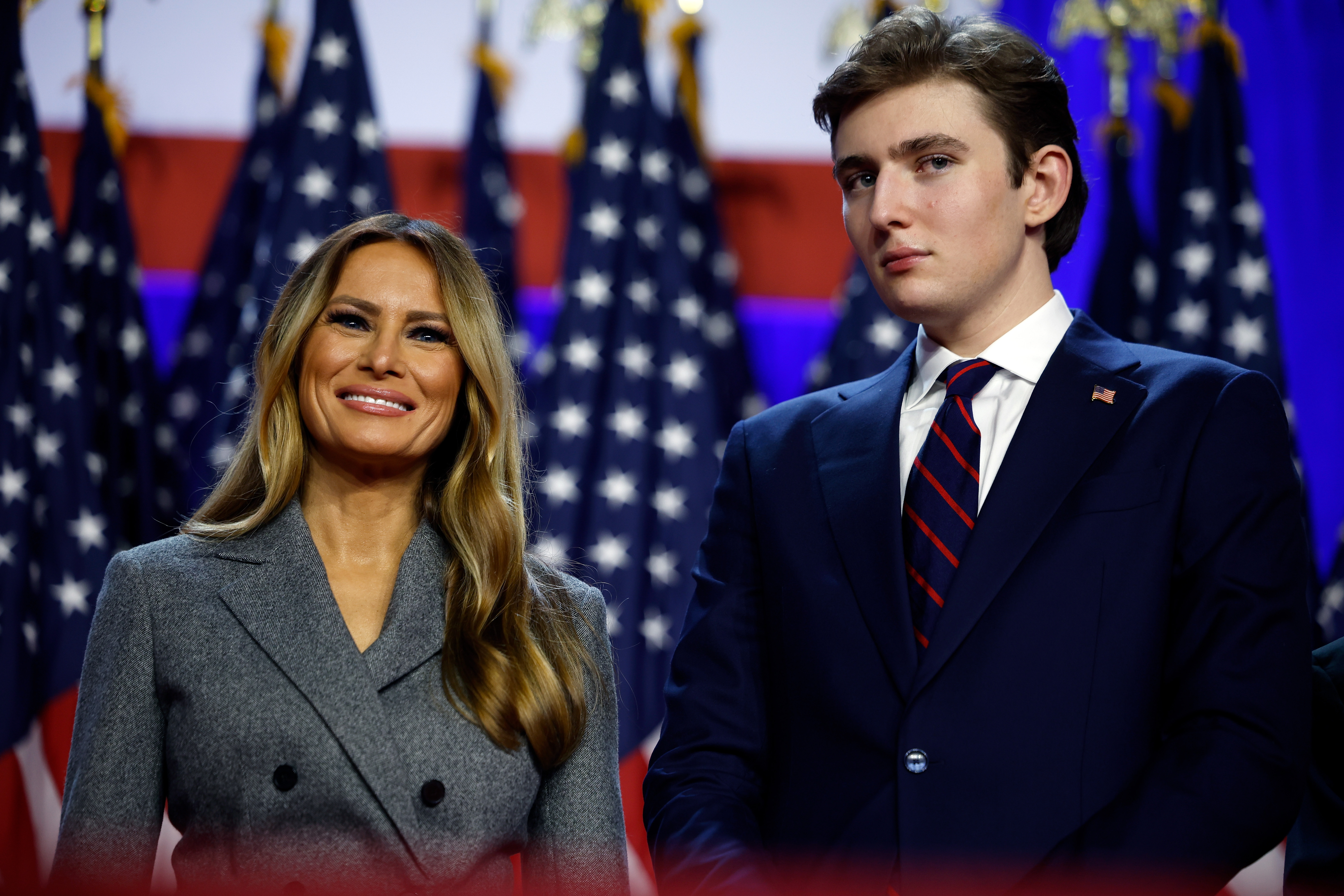 Melania Trump y Barron Trump miran mientras el presidente Donald Trump habla durante un acto de la noche electoral en el Centro de Convenciones de Palm Beach el 6 de noviembre de 2024, en Florida. | Fuente: Getty Images