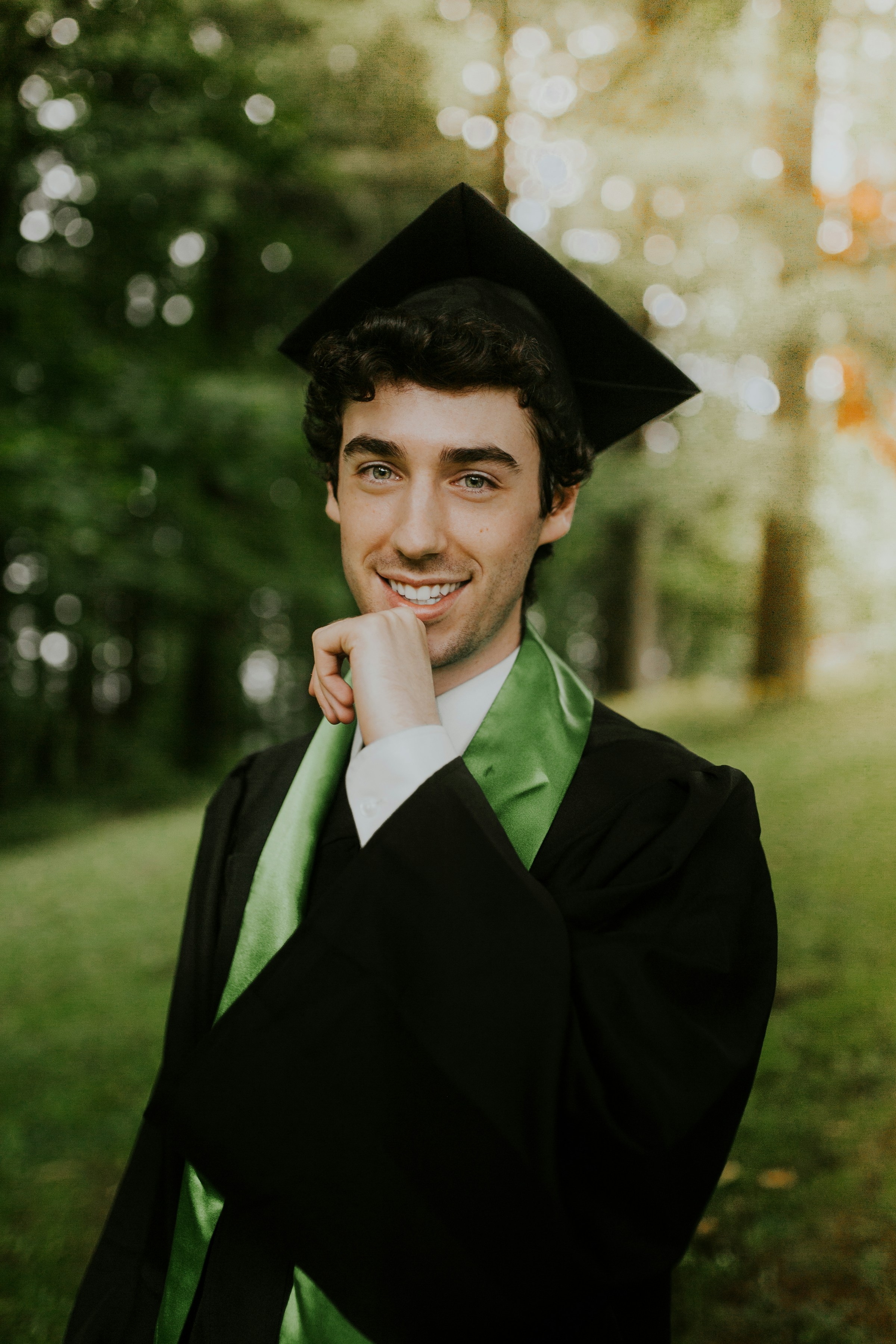 Un joven sonriente con un traje de graduación | Fuente: Unsplash