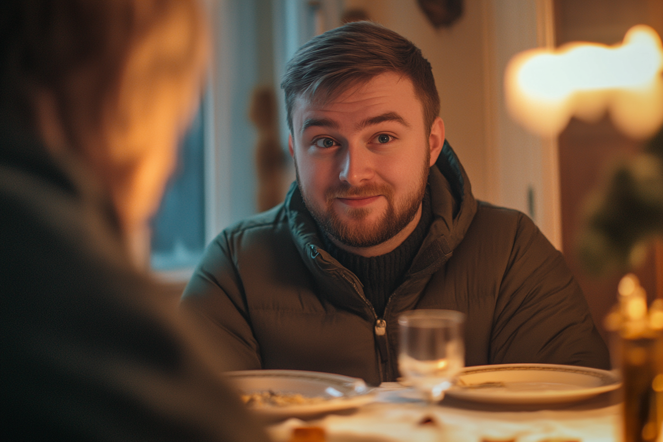 Hombre sentado a la mesa | Fuente: Midjourney