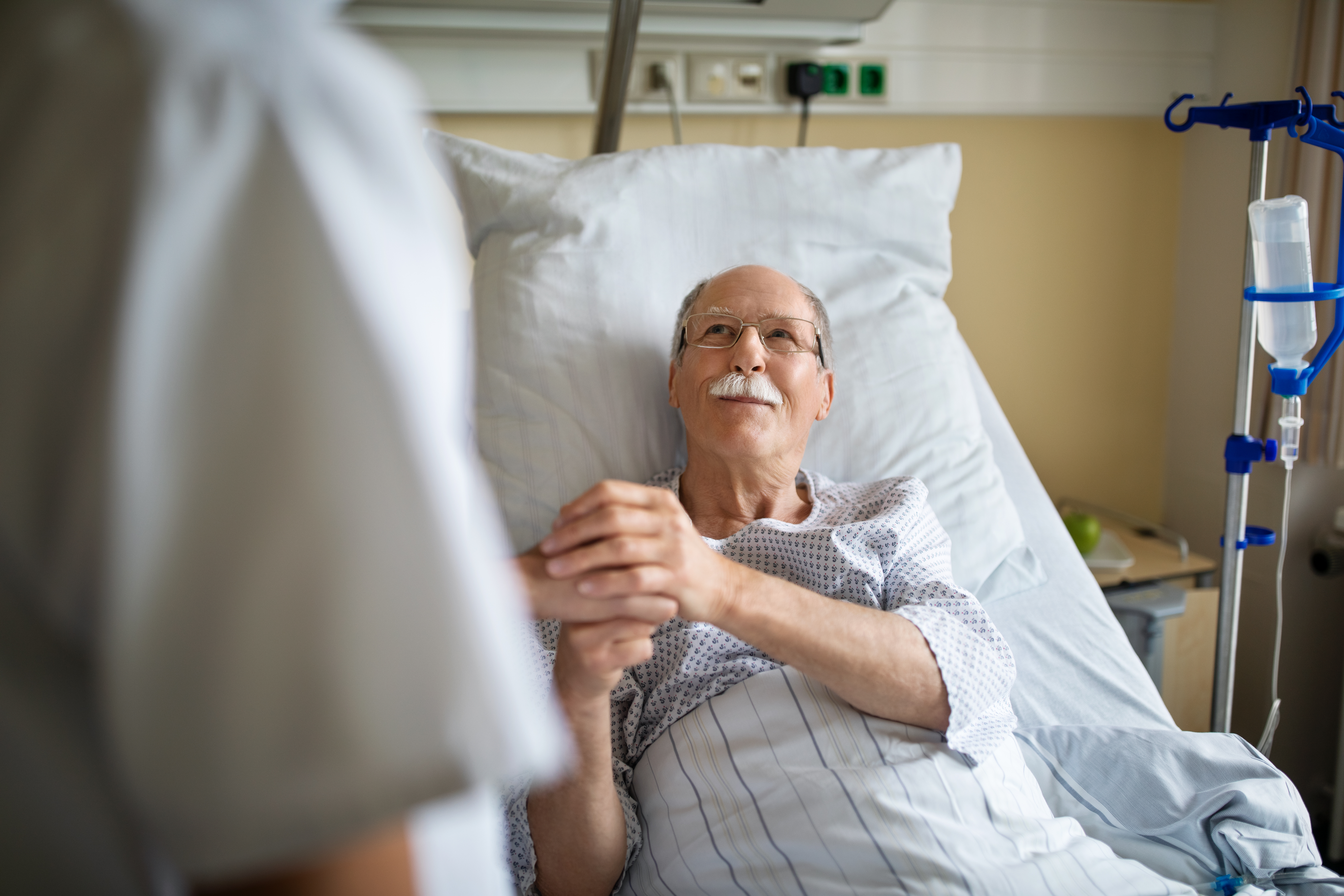 Hombre toma de la mano a una enfermera | Foto: Getty Images