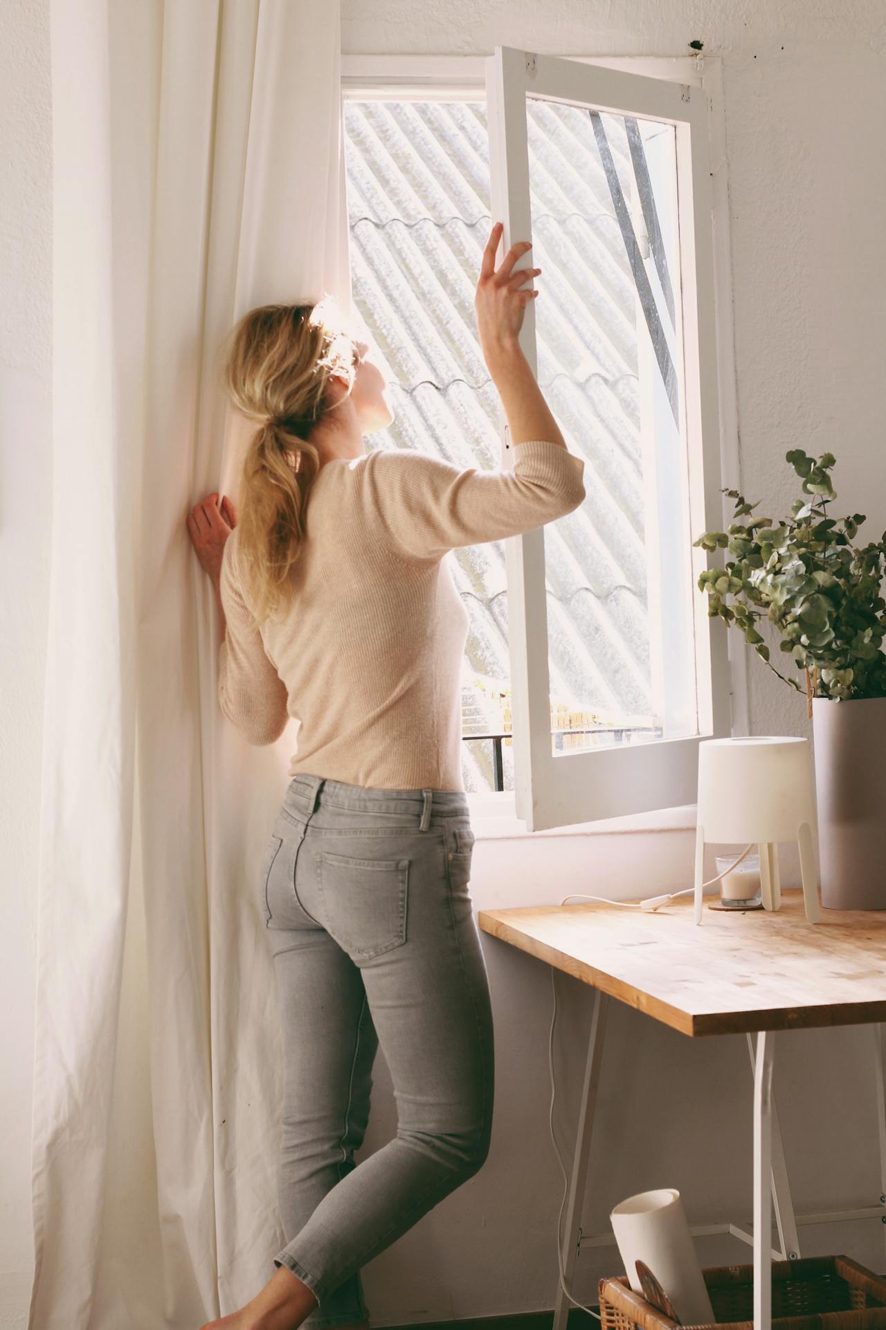 Una mujer mirando por la ventana | Fuente: Pexels