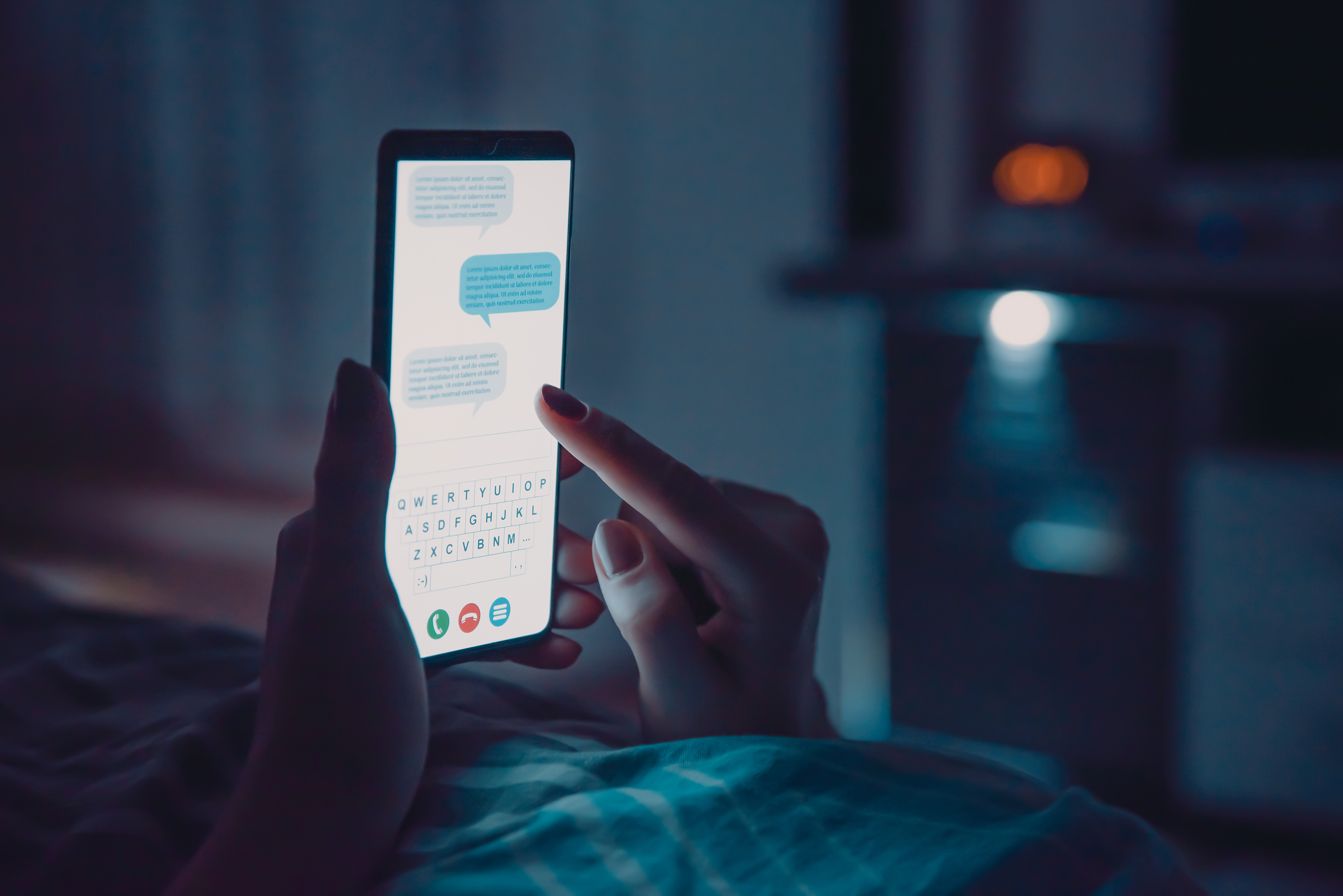 Mujer tumbada en la cama con un smartphone antes de dormir | Fuente: Shutterstock