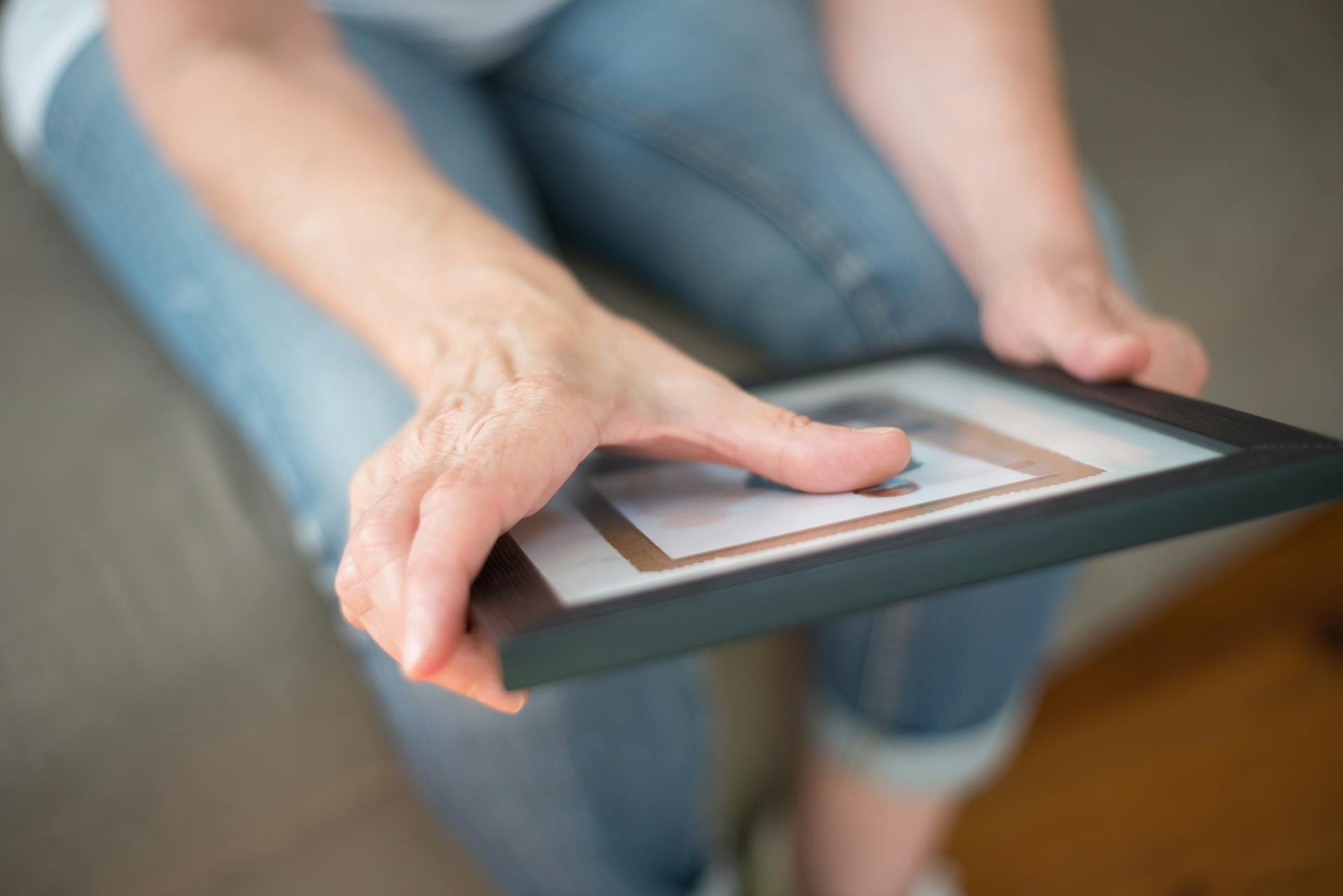 Una mujer sujetando un marco de fotos | Fuente: Pexels