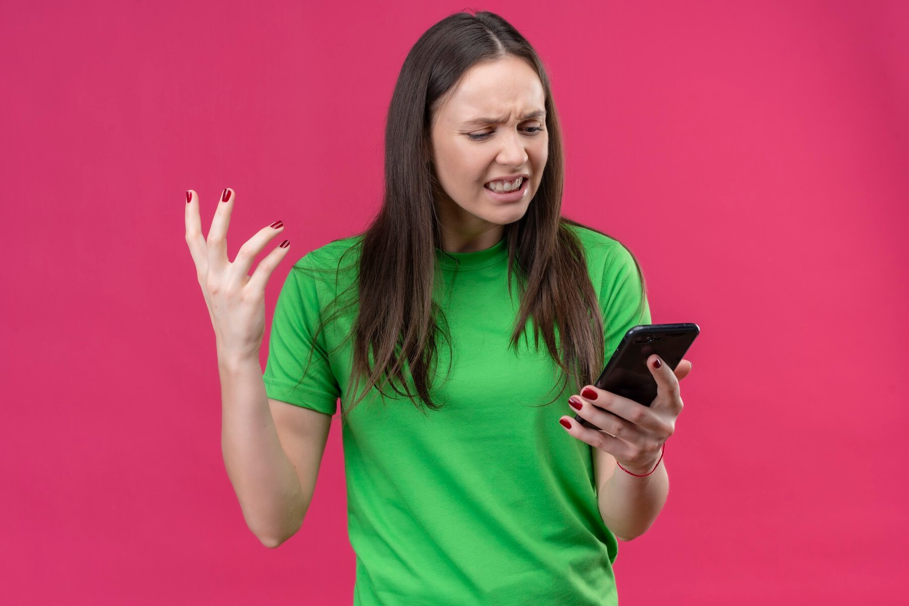 Una mujer enfadada mirando su teléfono | Fuente: Freepik