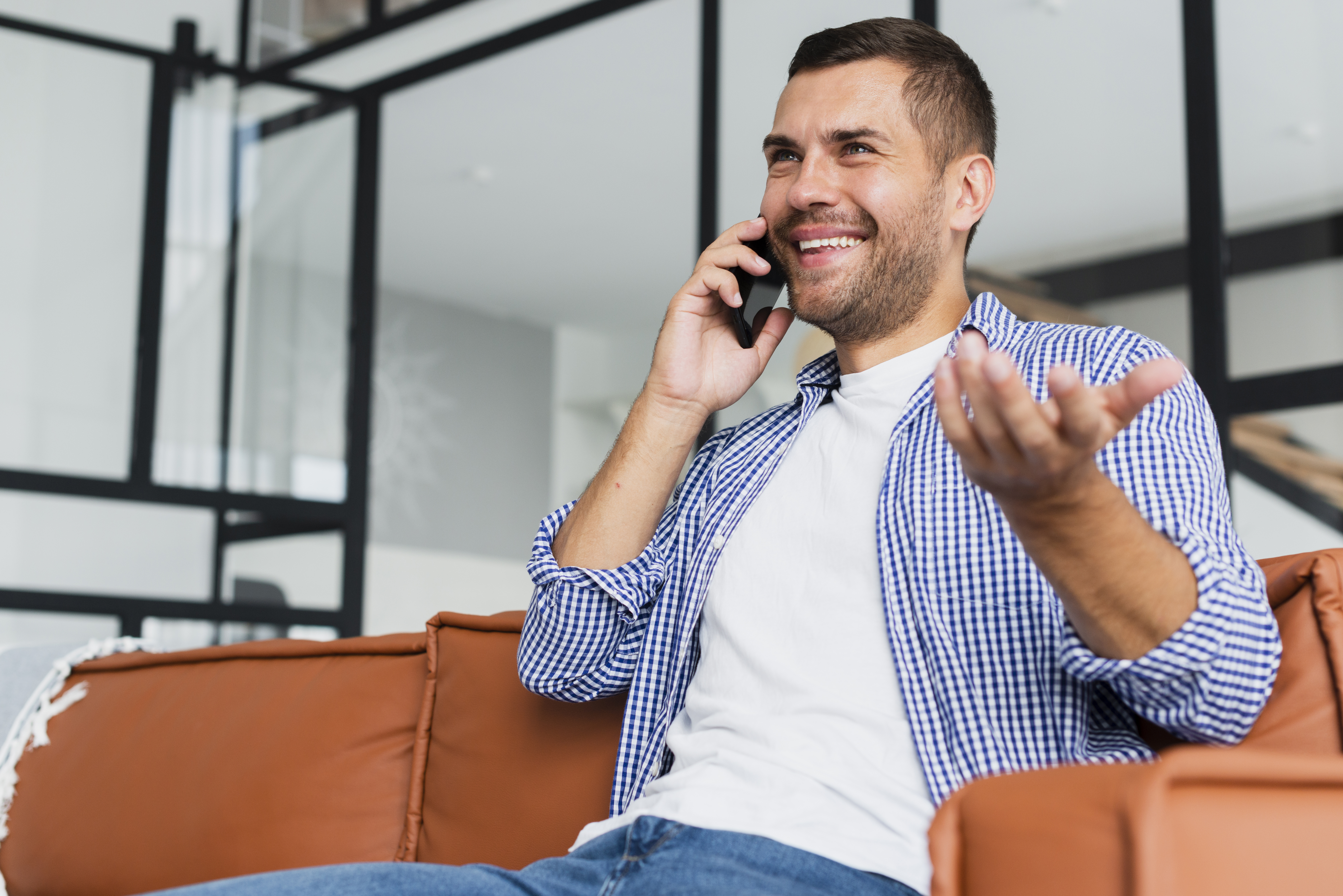 Hombre hablando por teléfono sonriendo | Fuente: Freepik