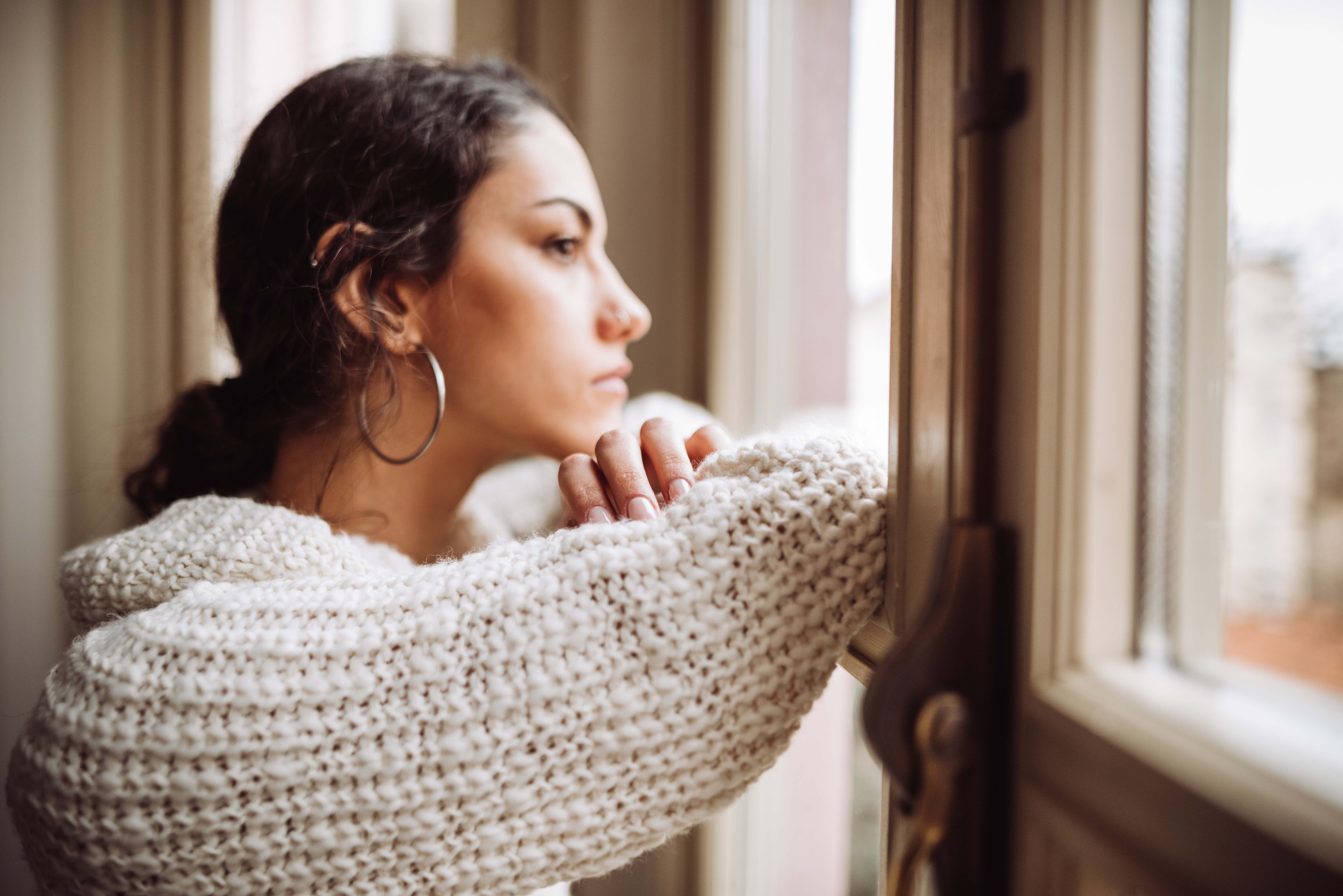 Una mujer pensativa frente a la ventana | Fuente: Getty Images