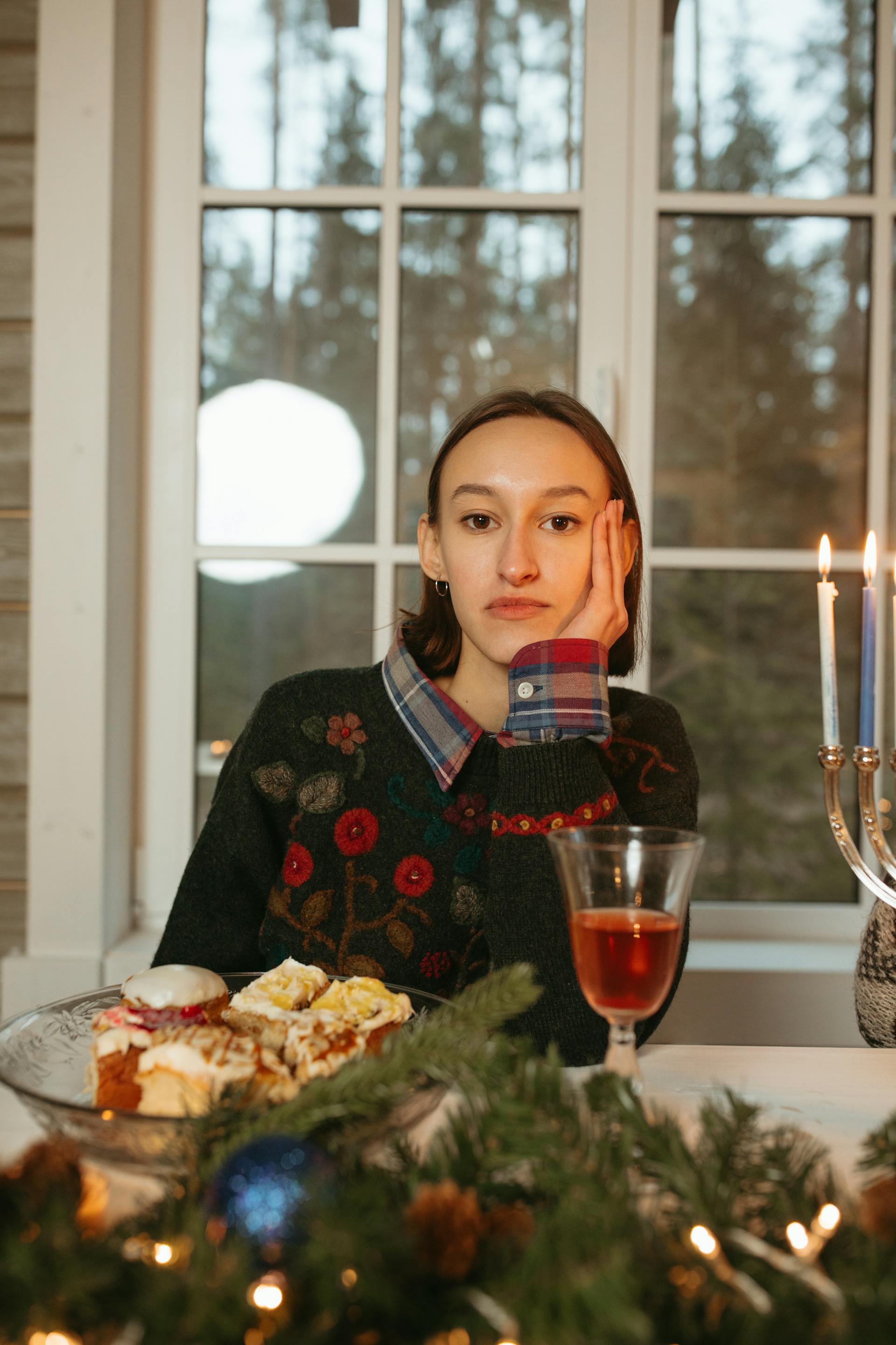 Una mujer sentada a una mesa con un plato de tarta de frutas | Fuente: Pexels