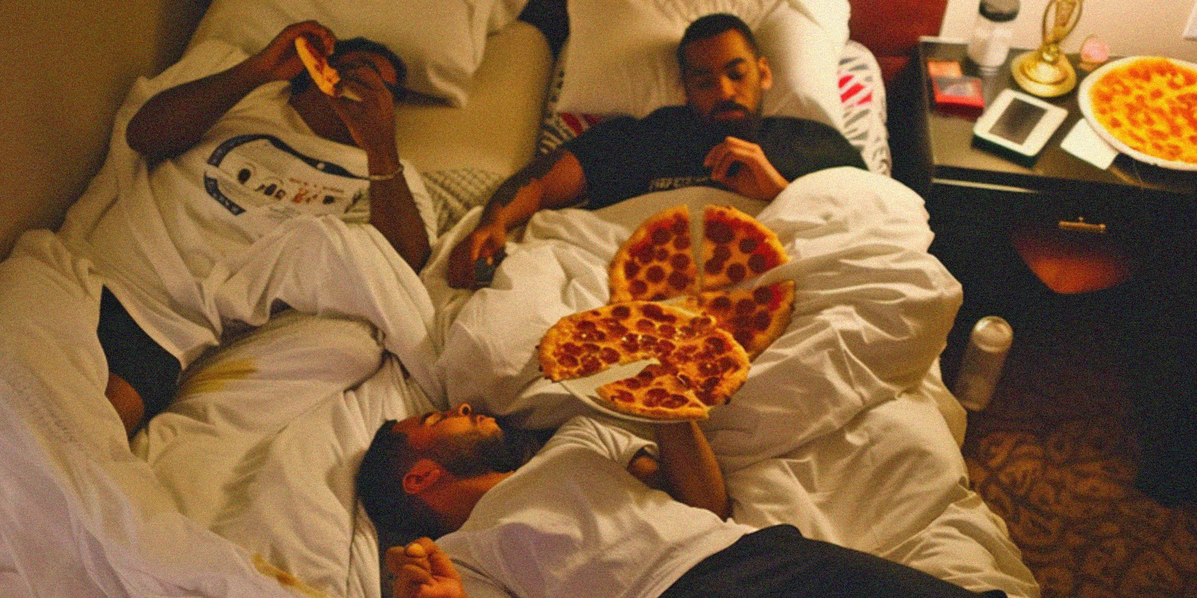 Hombres disfrutando de una fiesta de pizza | Fuente: AmoMama
