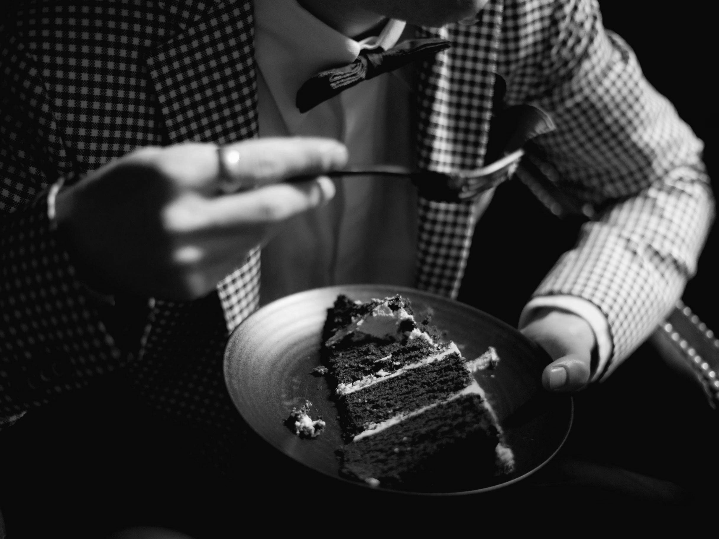 A guest enjoying a slice of wedding cake | Source: Pexels