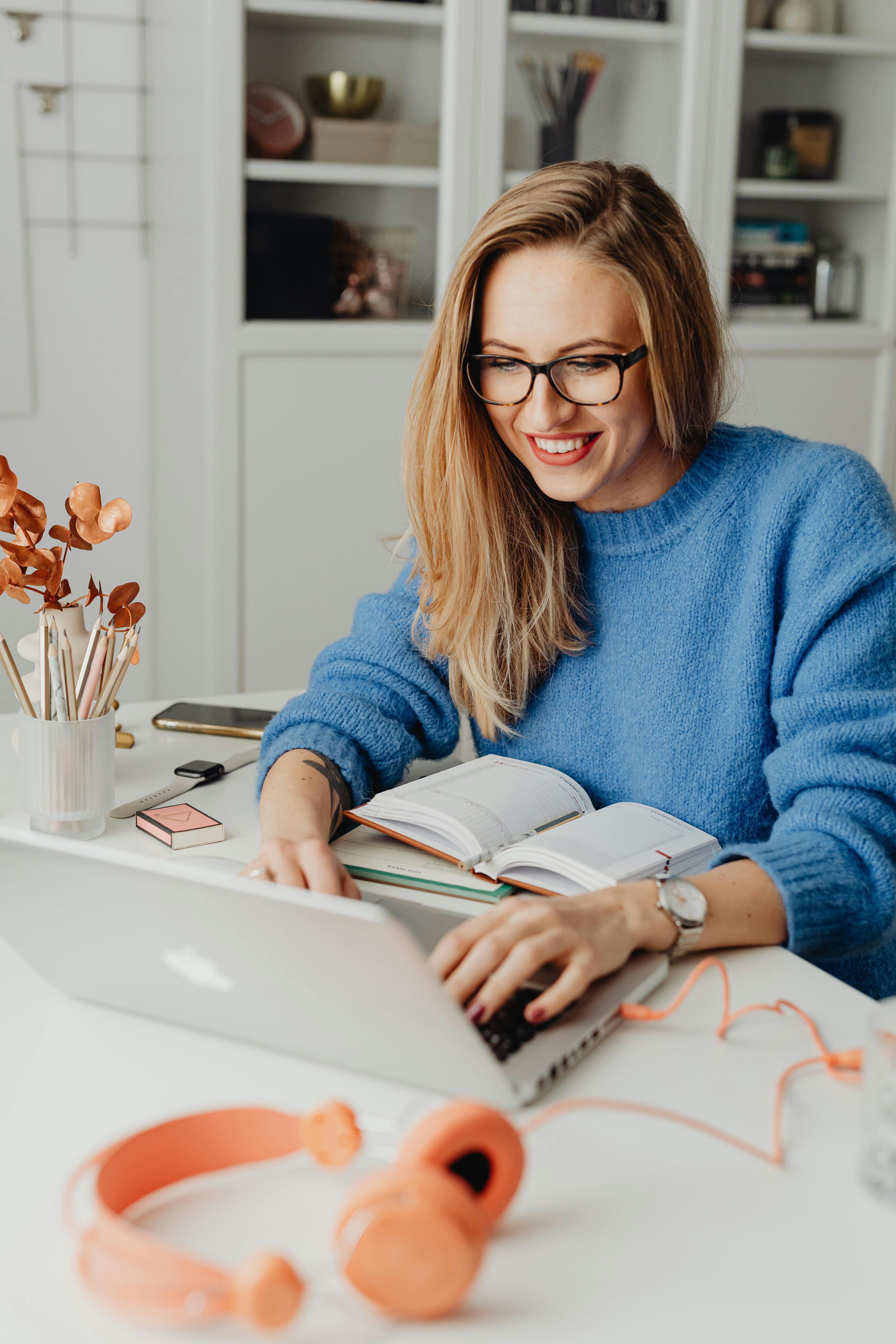 Una mujer feliz utilizando un portátil | Fuente: Pexels