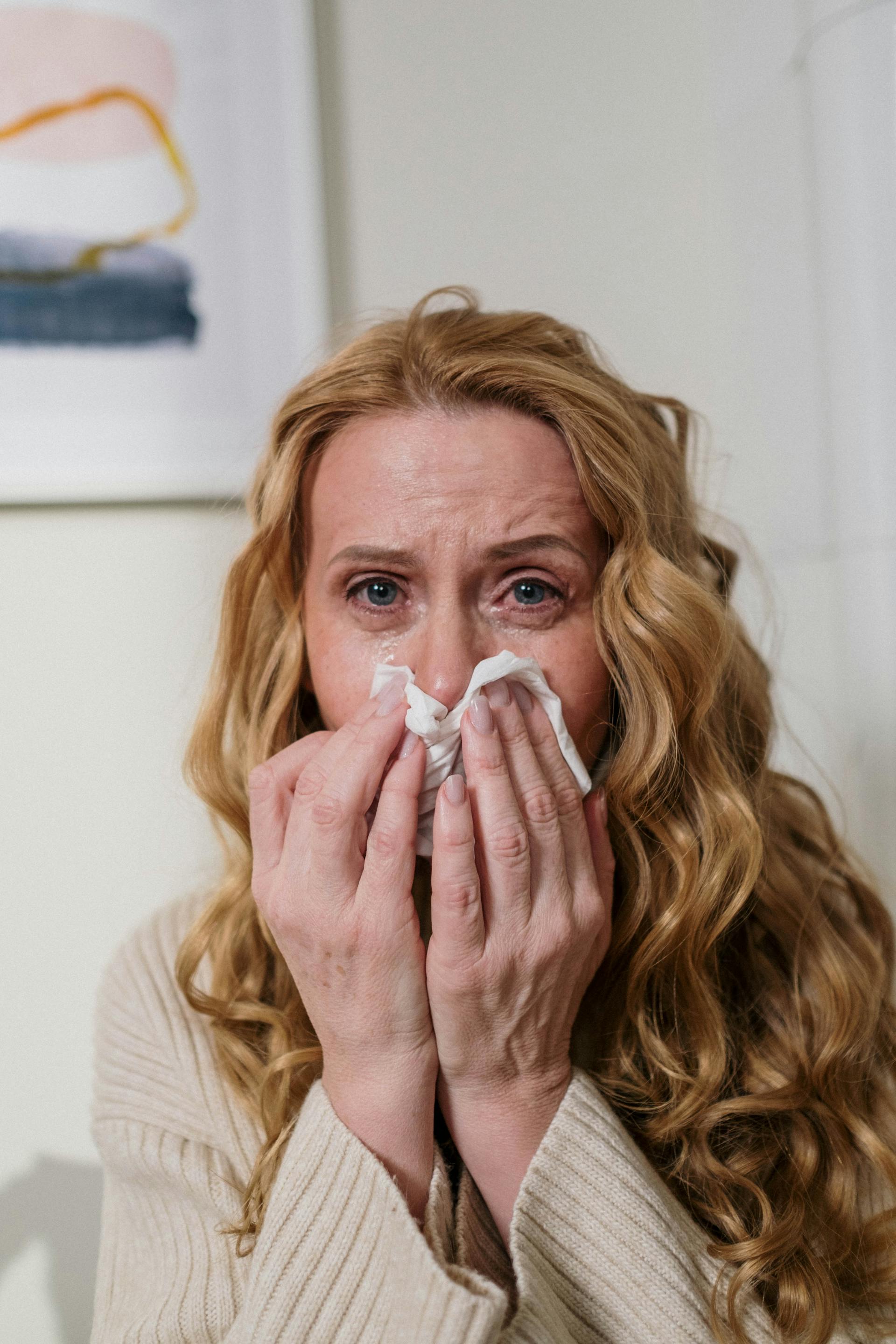 Una mujer se limpia la nariz con un pañuelo mientras llora | Fuente: Pexels