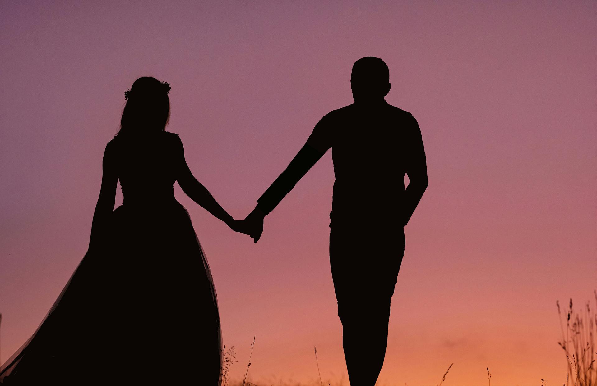 Silueta de una pareja tomada de la mano | Fuente: Pexels