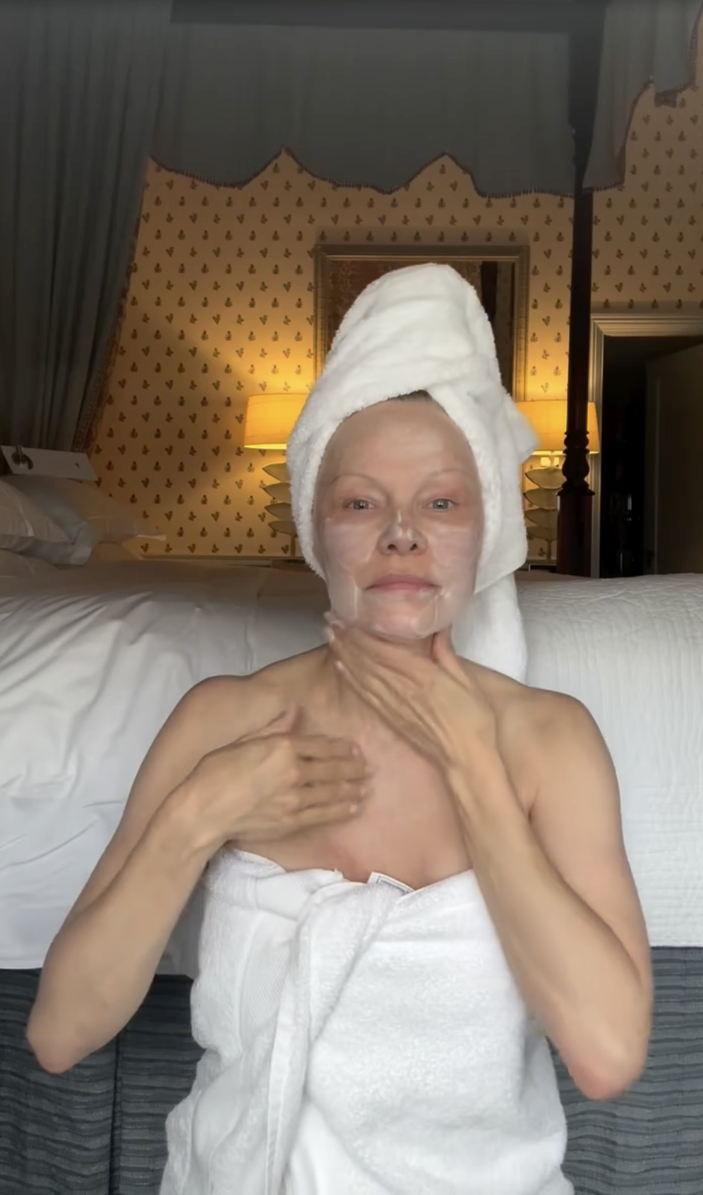 Pamela Anderson se aplica crema hidratante, envuelta en toallas y con un turbante a juego, tras su rutina matutina. Irradiando una aceptación natural de sí misma, celebró el aniversario de su línea de cuidado de la piel, Sonsie Skin, acompañando el vídeo, grabado en su dormitorio y sin maquillaje, con una reflexión profunda: "Buenos días, mundo… 🤍 Hoy es un día de bendición, ya que celebramos otro cumpleaños de @sonsieskin. El universo está concediendo deseos… ¿cuáles son los tuyos? El mío es ser aún más agradecida, juguetona… y sabia. ✨ Con cariño, P". | Fuente: Instagram/pamelaanderson