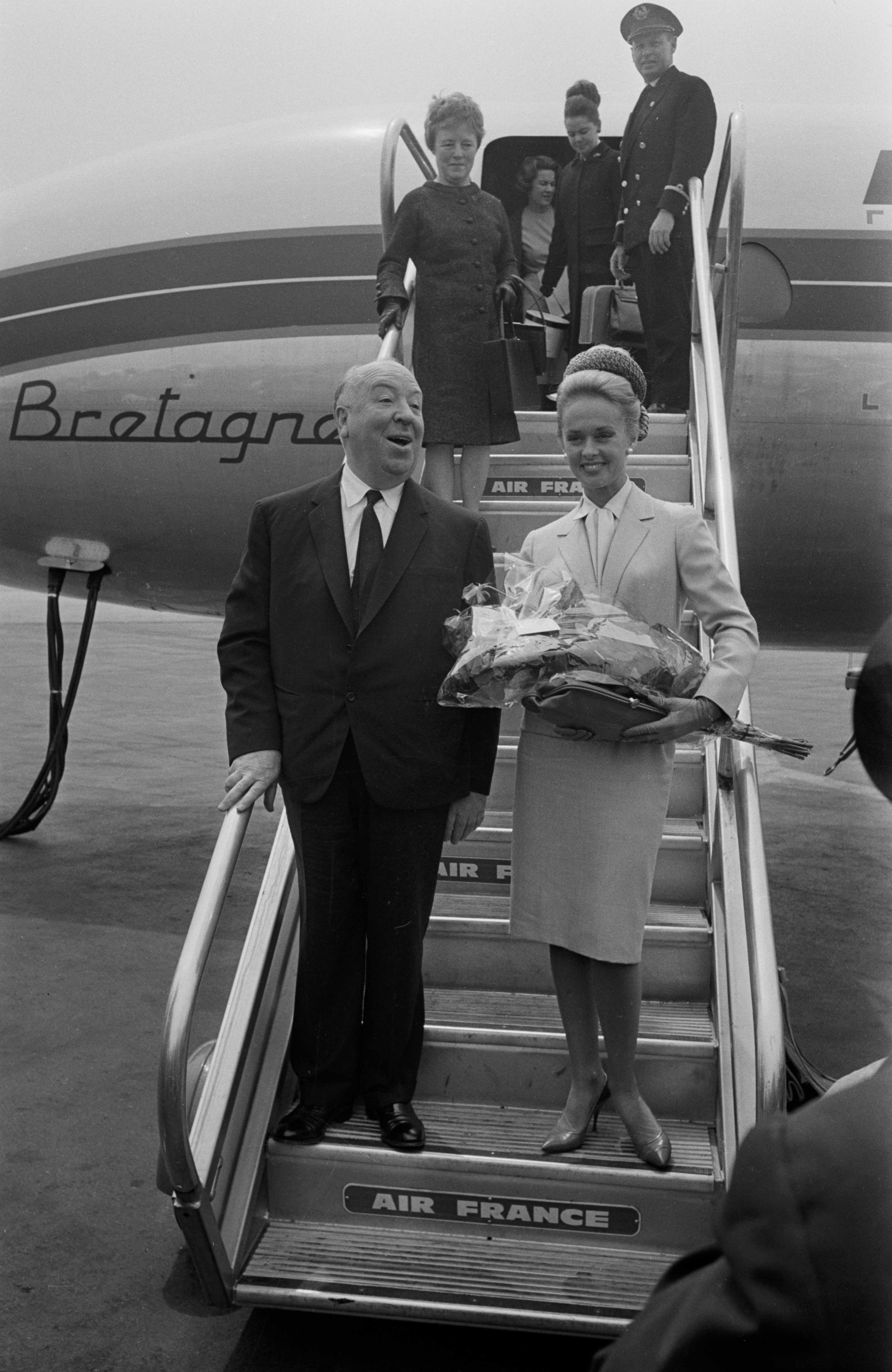 Alfred Hitchcock y Tippi Hedren en el aeropuerto de Niza para asistir al Festival de Cine de Cannes, Francia, el 11 de mayo de 1963. | Fuente: Getty Images