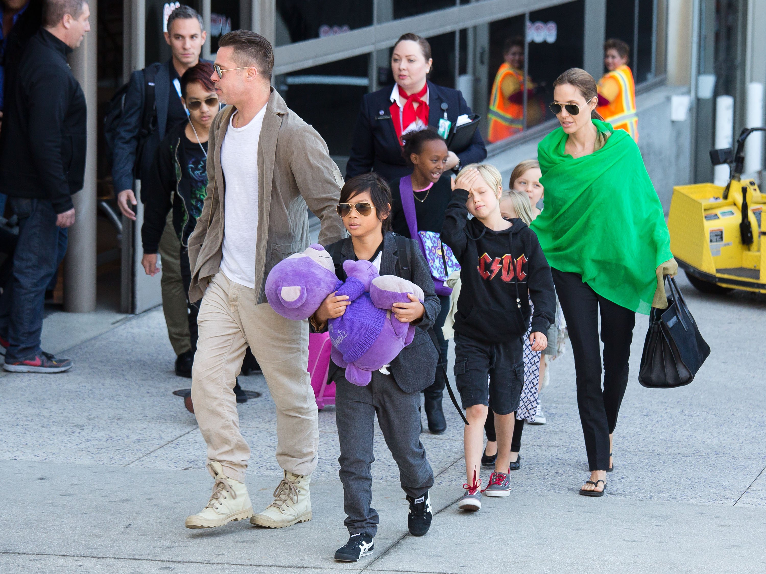 Brad Pitt y Angelina Jolie tras aterrizar en el aeropuerto internacional de Los Ángeles con sus hijos, Pax, Maddox, Shiloh, Zahara, Vivienne y Knox Jolie-Pitt el 5 de febrero de 2014, en California. | Foto: Getty Images
