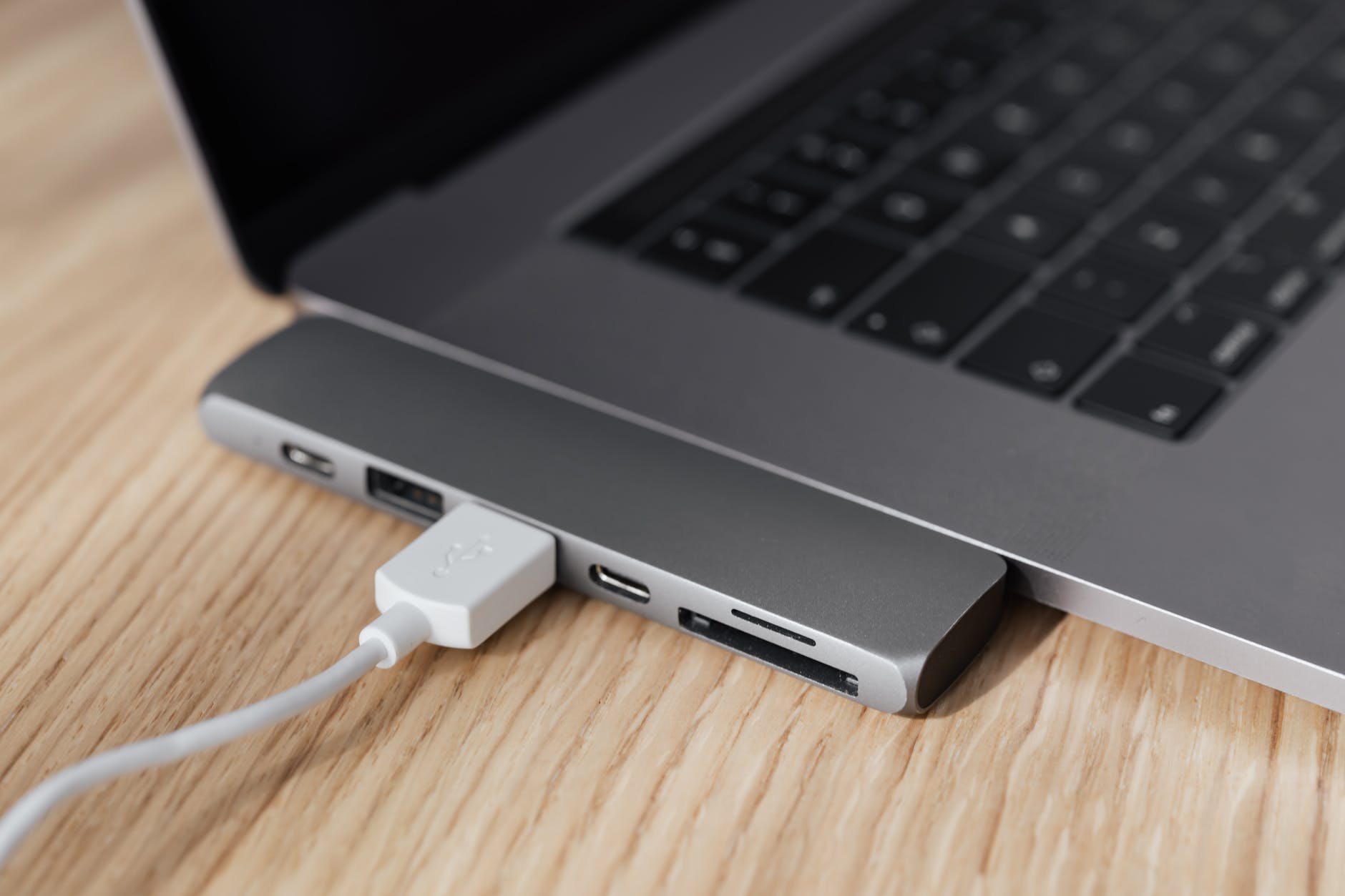Laptop con un cable USB. | Foto: Pexels