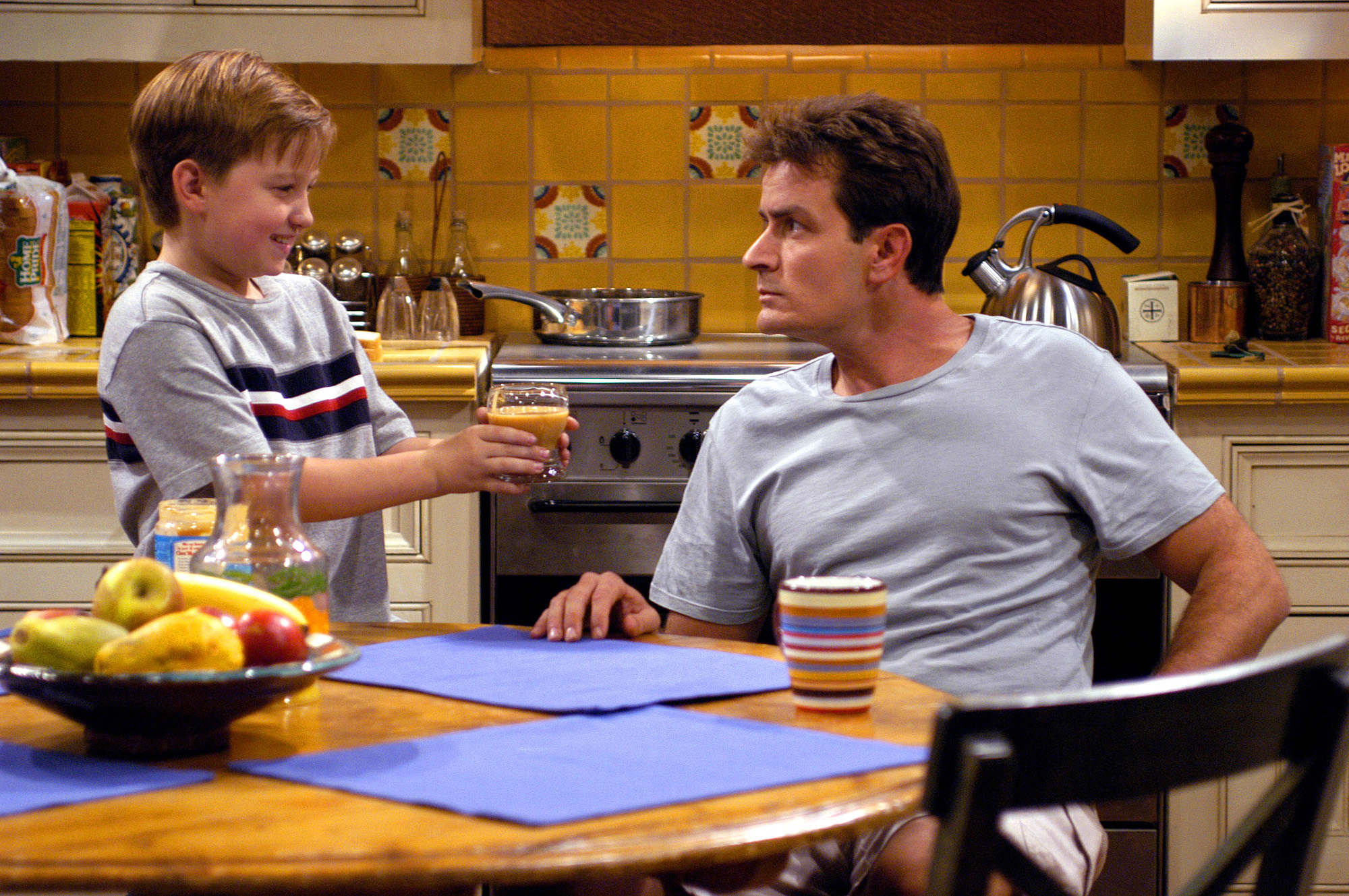 Angus T. Jones y Charlie Sheen en el plató de "Two and a Half Men", 2003 | Fuente: Getty Images