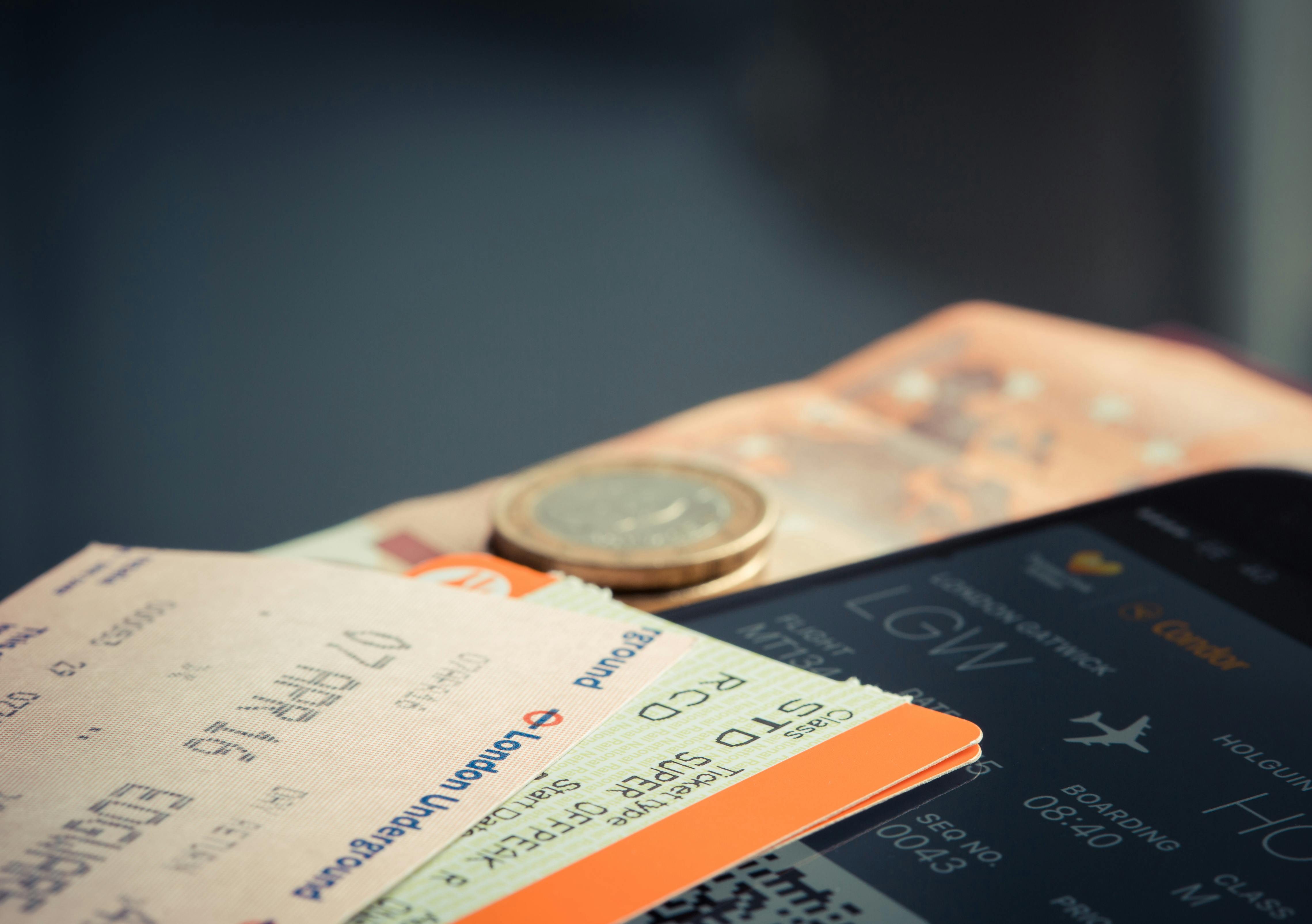 Billetes de avión sobre una mesa con dinero | Foto: Pexels