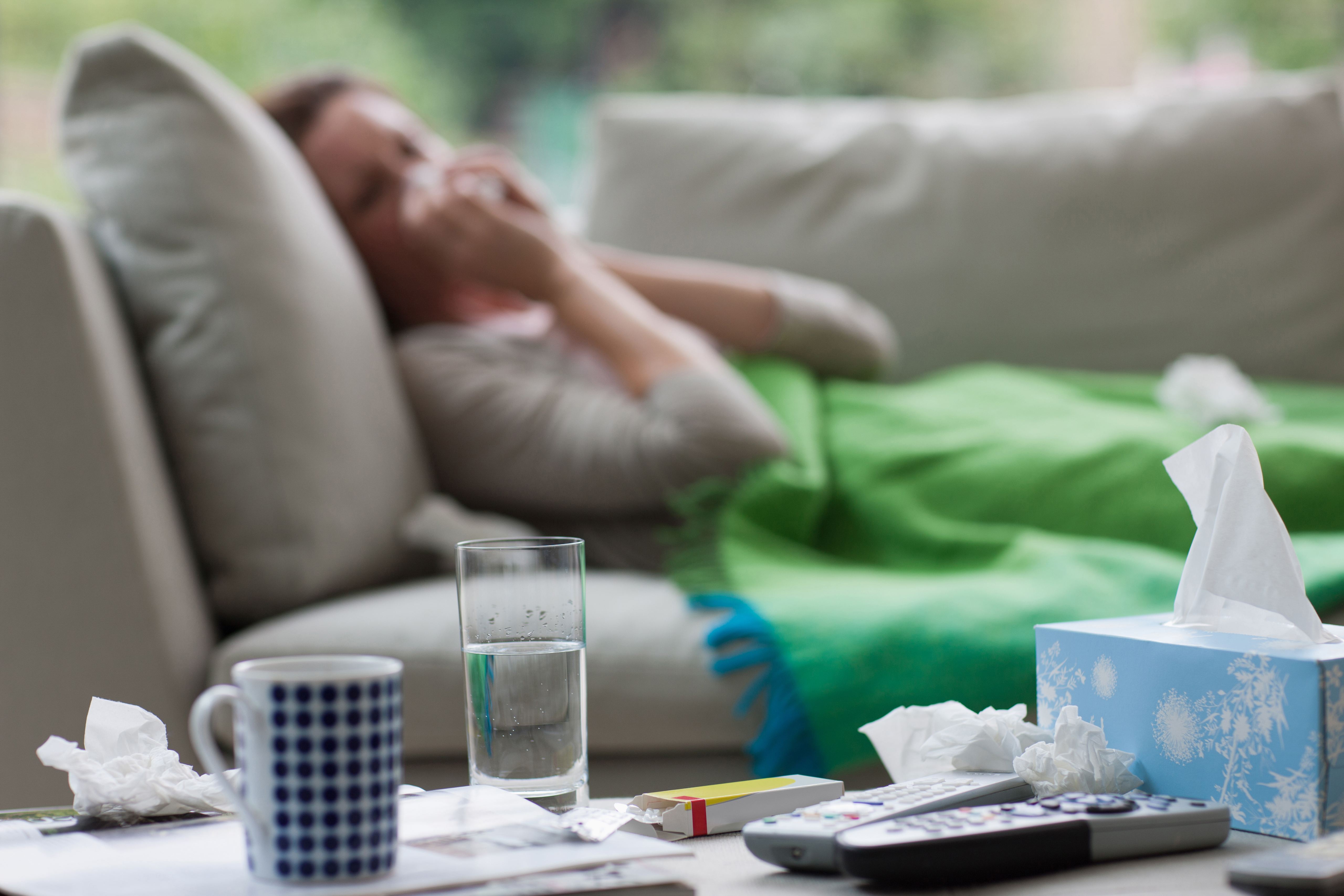 Una mujer enferma tumbada en el sofá | Foto: Getty Images