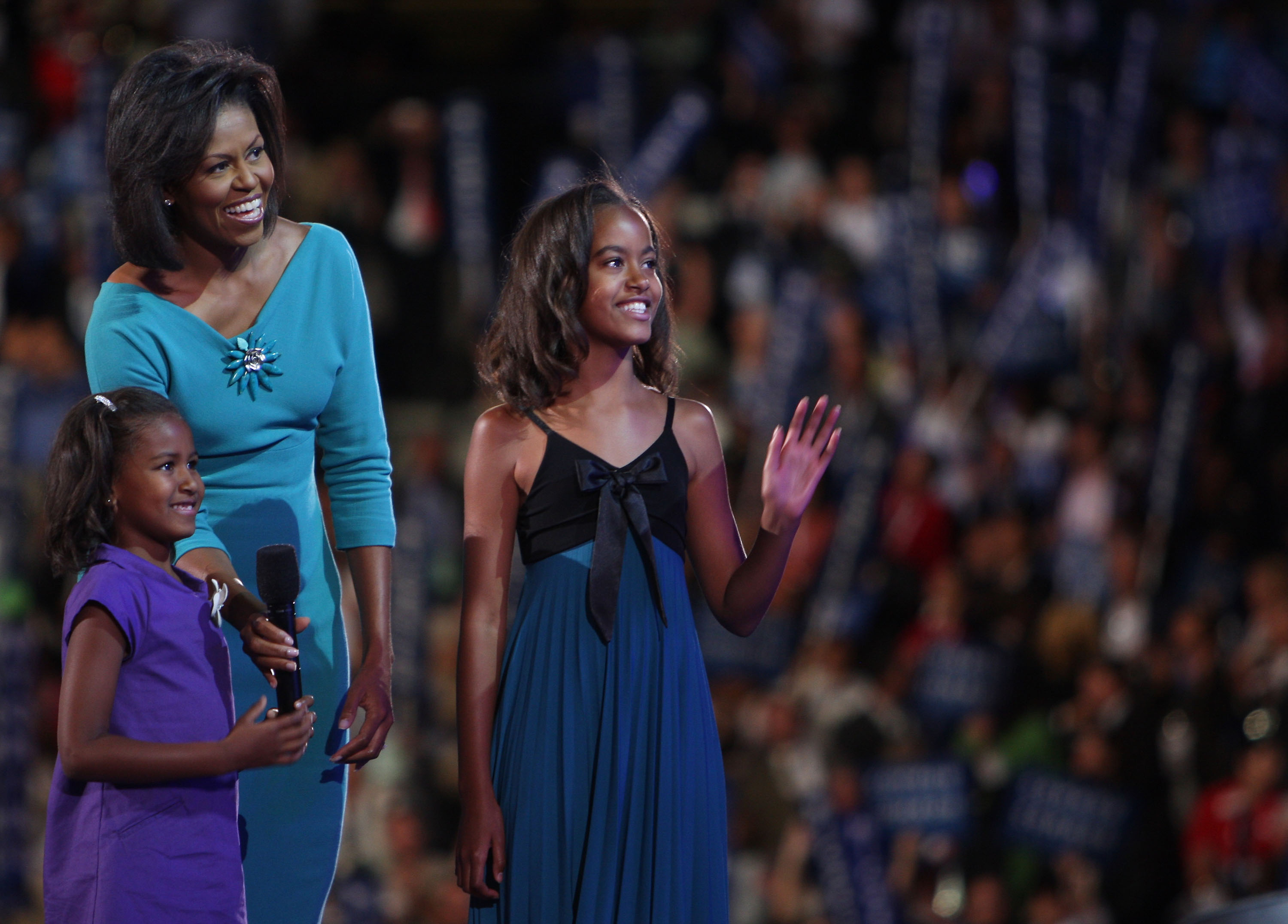 Michelle Obama junto a sus hijas Sasha y Malia Obama en el escenario durante el primer día de la Convención Nacional Demócrata (DNC) el 25 de agosto de 2008, en Denver, Colorado | Fuente: Getty Images