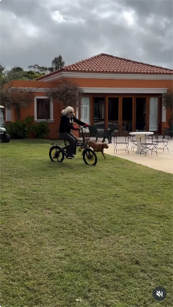 Susana Giménez durante un paseo en bicicleta en el jardín de su mansión junto a sus perritos | Fuente: Instagram/gimenezsuok