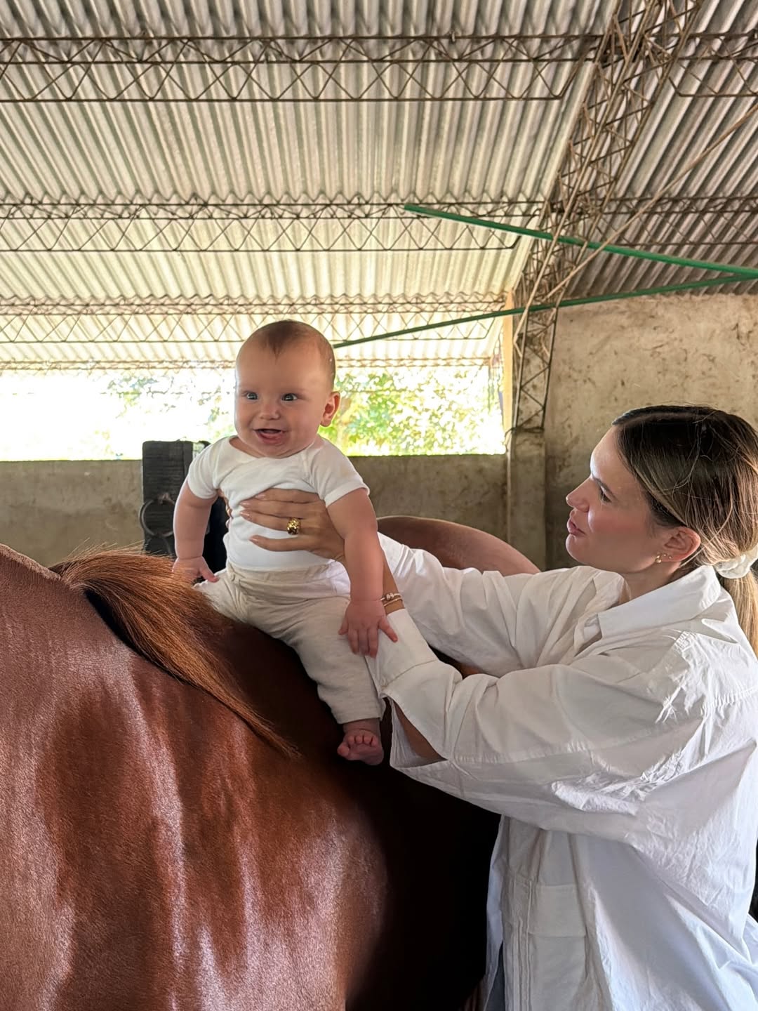 Eva Bargiela colocando a su hijo Faustino sobre un caballo | Fuente: Instagram /evabargiela