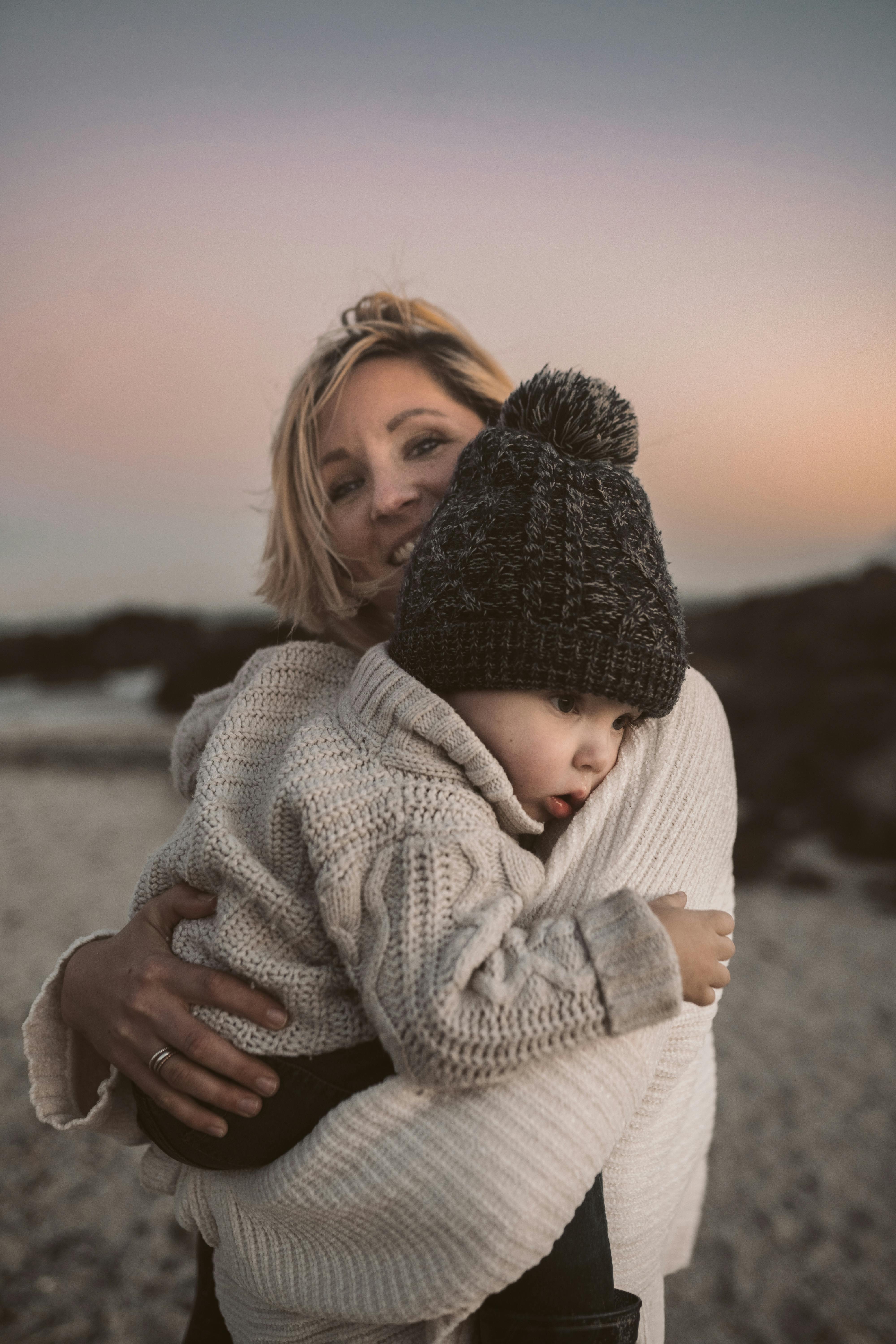 Mujer y su bebé en la playa | Fuente: Pexels