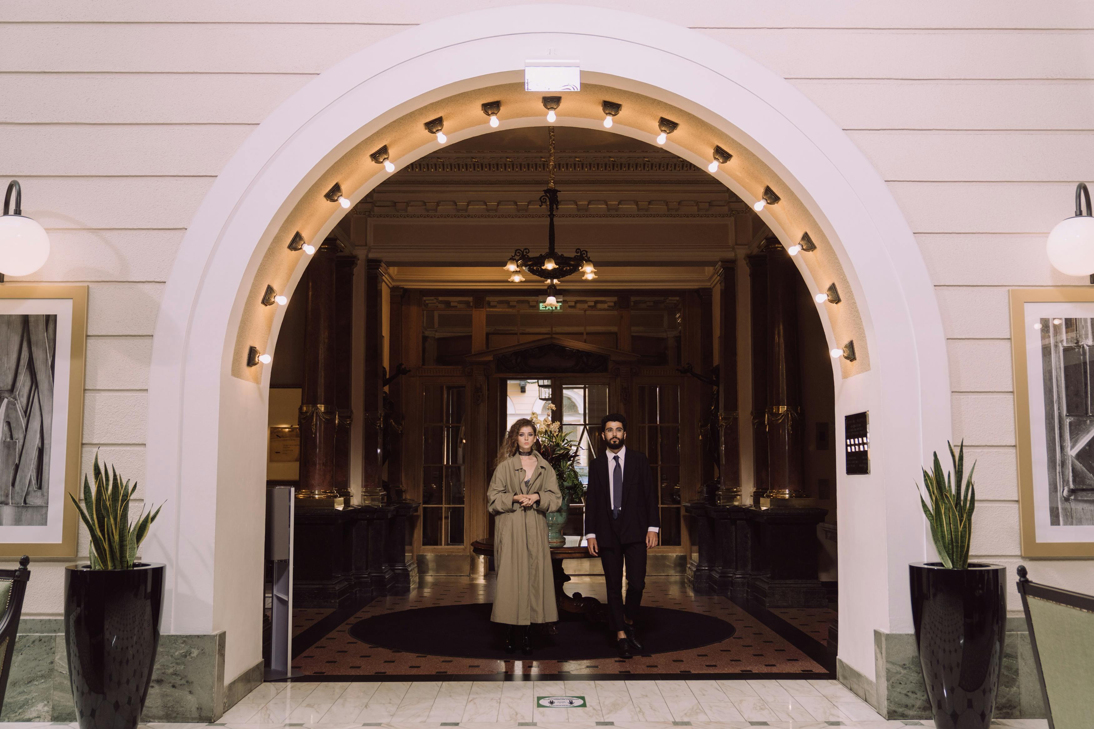 Dos personas en la entrada de un hotel | Fuente: Pexels