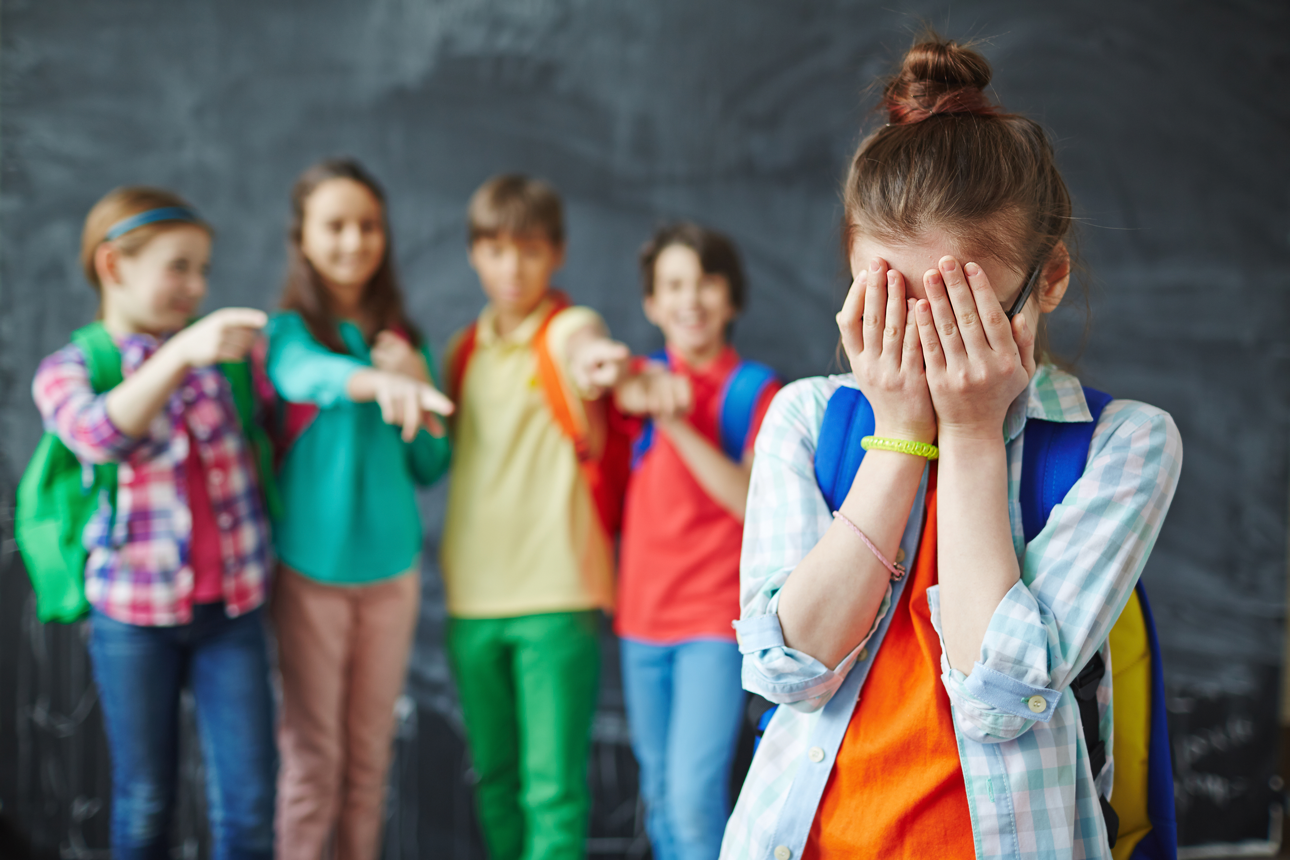 Un grupo de niños matones y una niña llorando | Foto: Shutterstock
