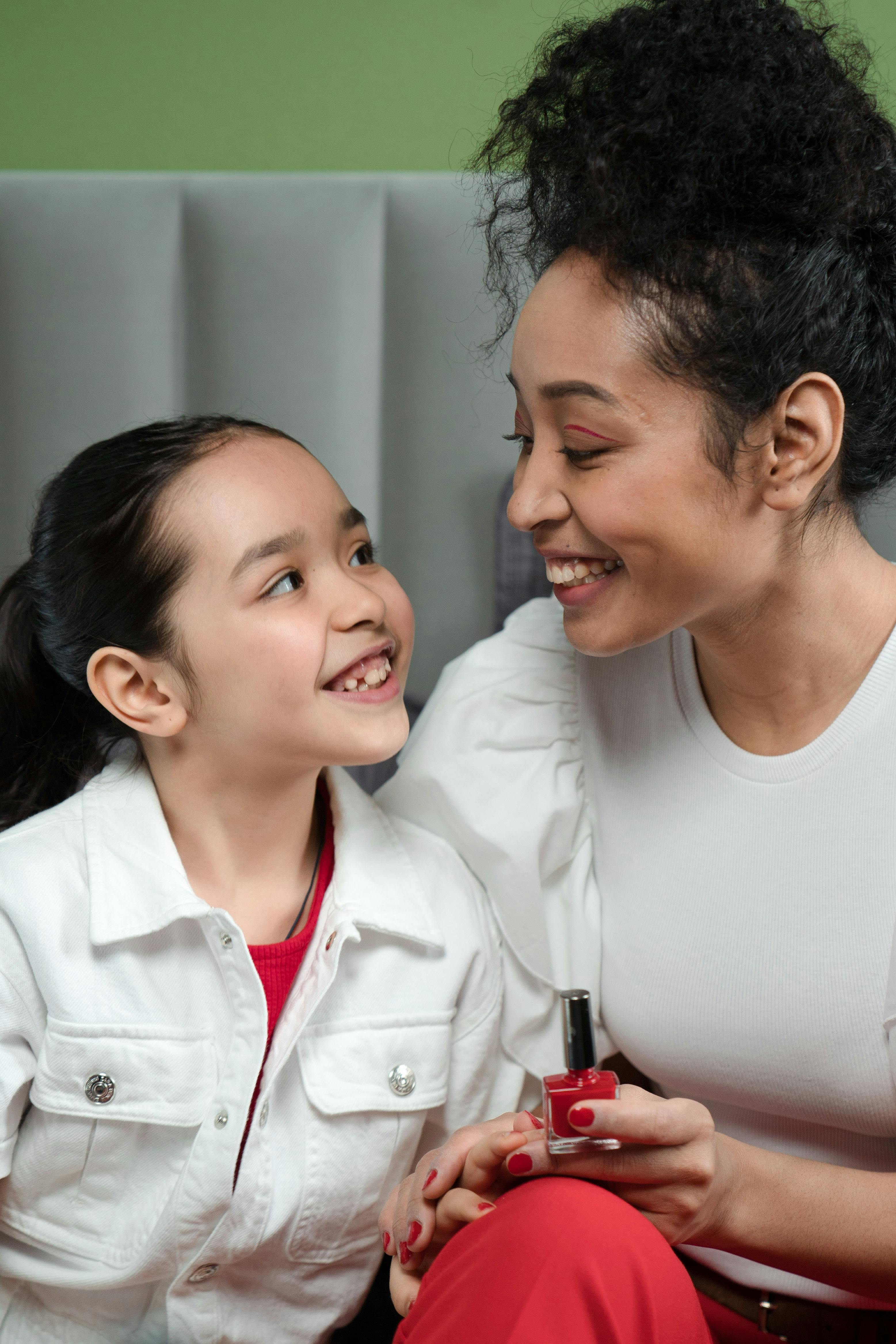 Mujer y niña sonriendo | Foto: Pexels