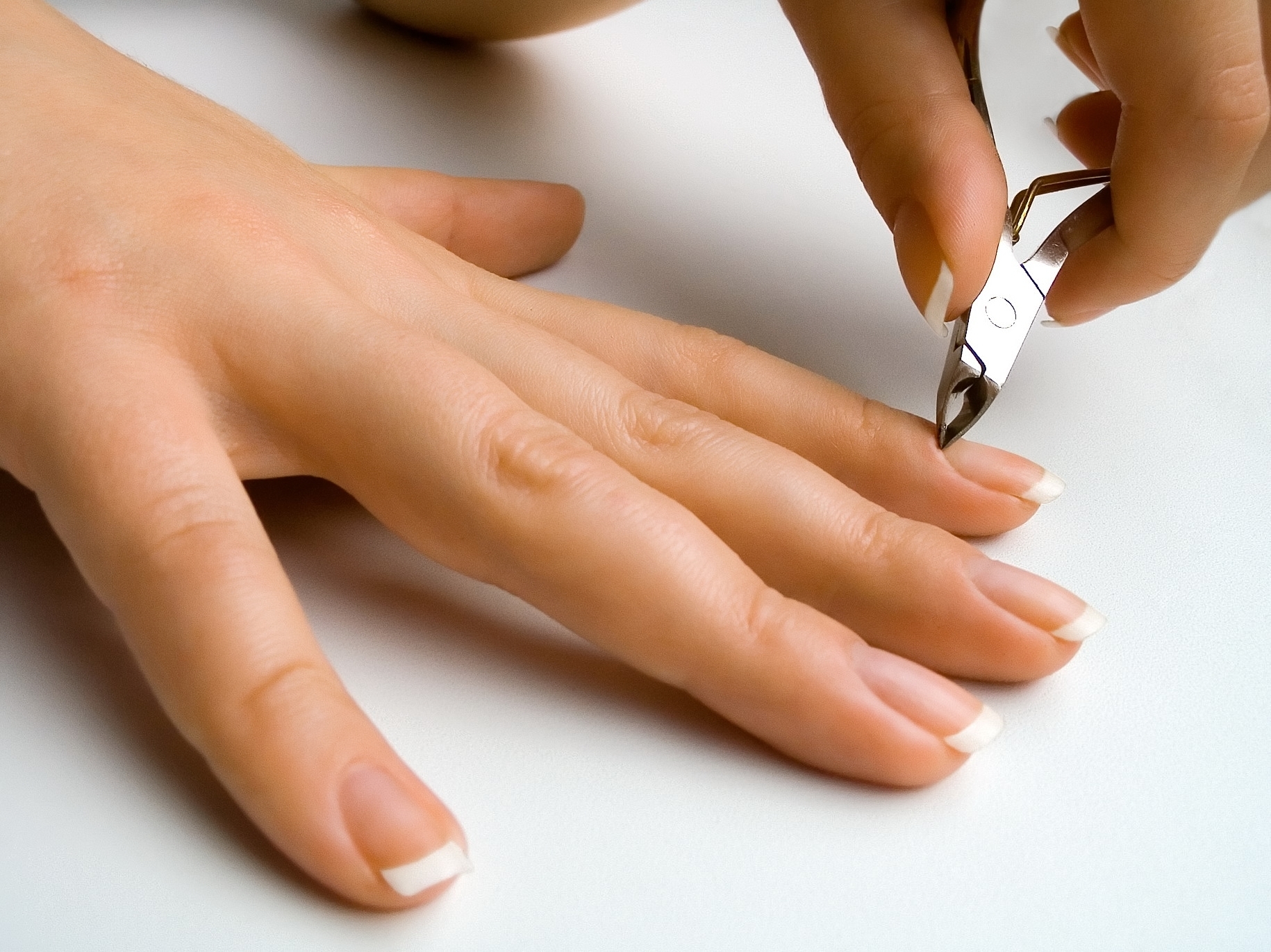 Una persona retirando las cutículas de las uñas | Fuente: Shutterstock